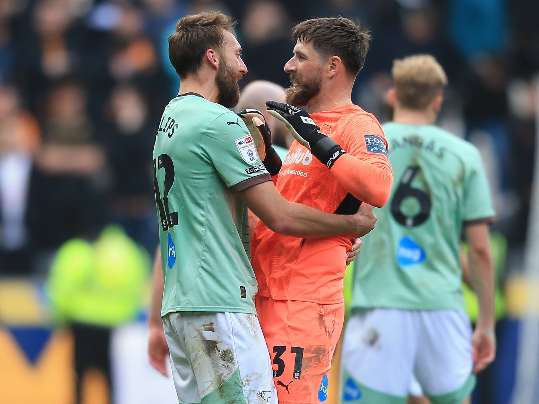 A photo of Nat Phillips embracing their goalkeeper after a win in the Sky Bet Championship
