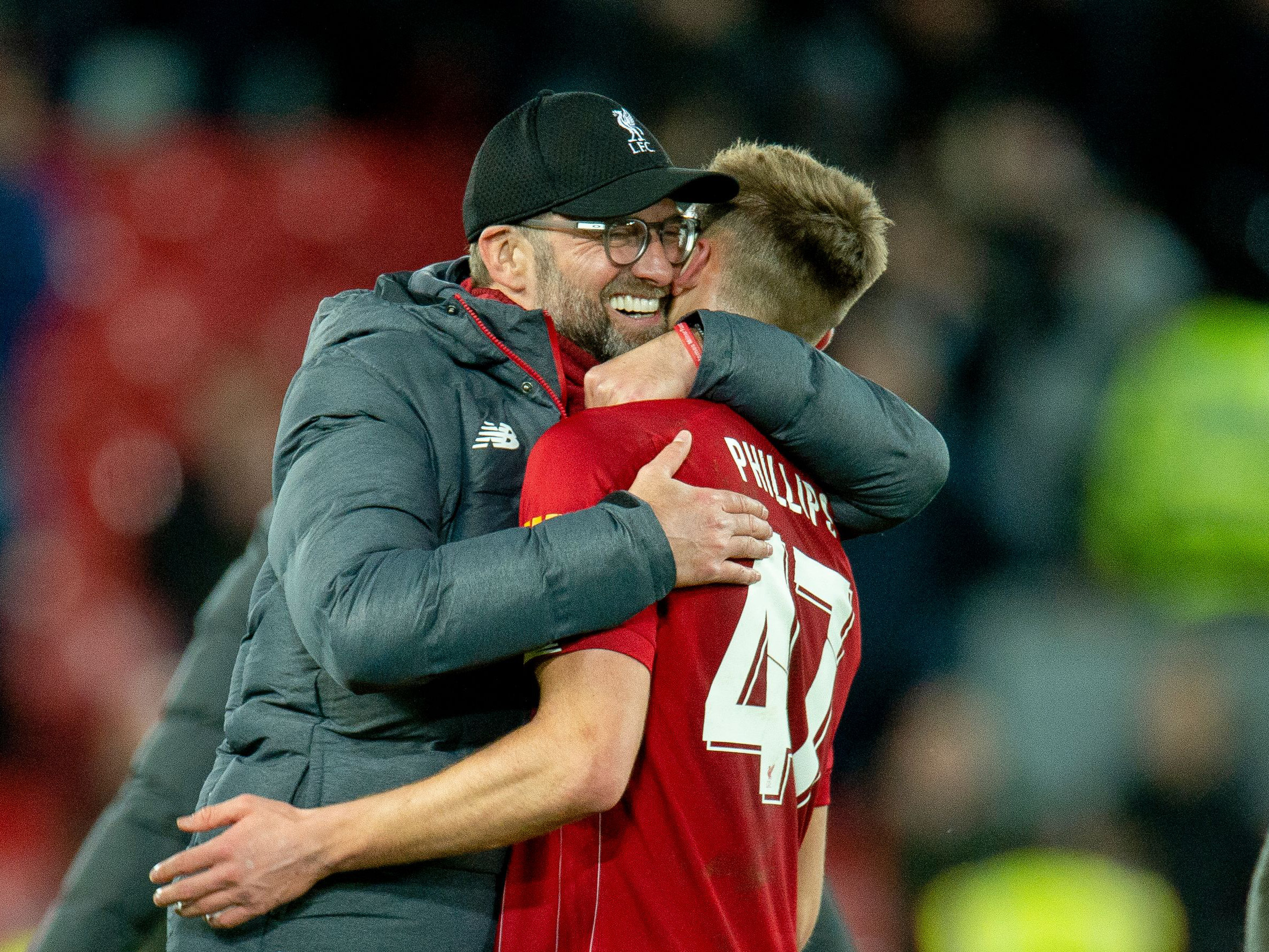 A photo of Nat Phillips and former Liverpool manager Jurgen Klopp embracing at Anfield