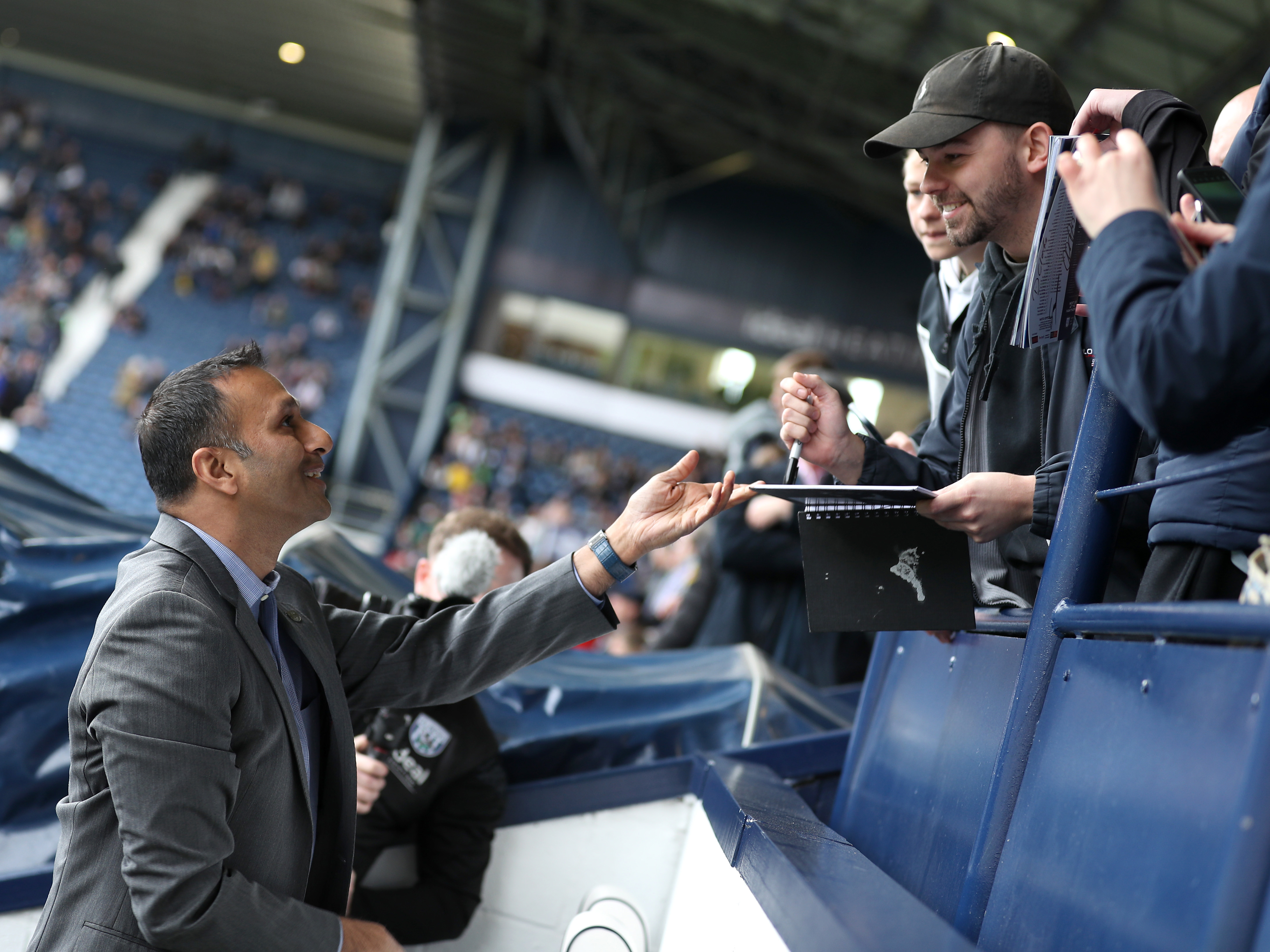 An image of Shilen Patel talking to Albion supporters