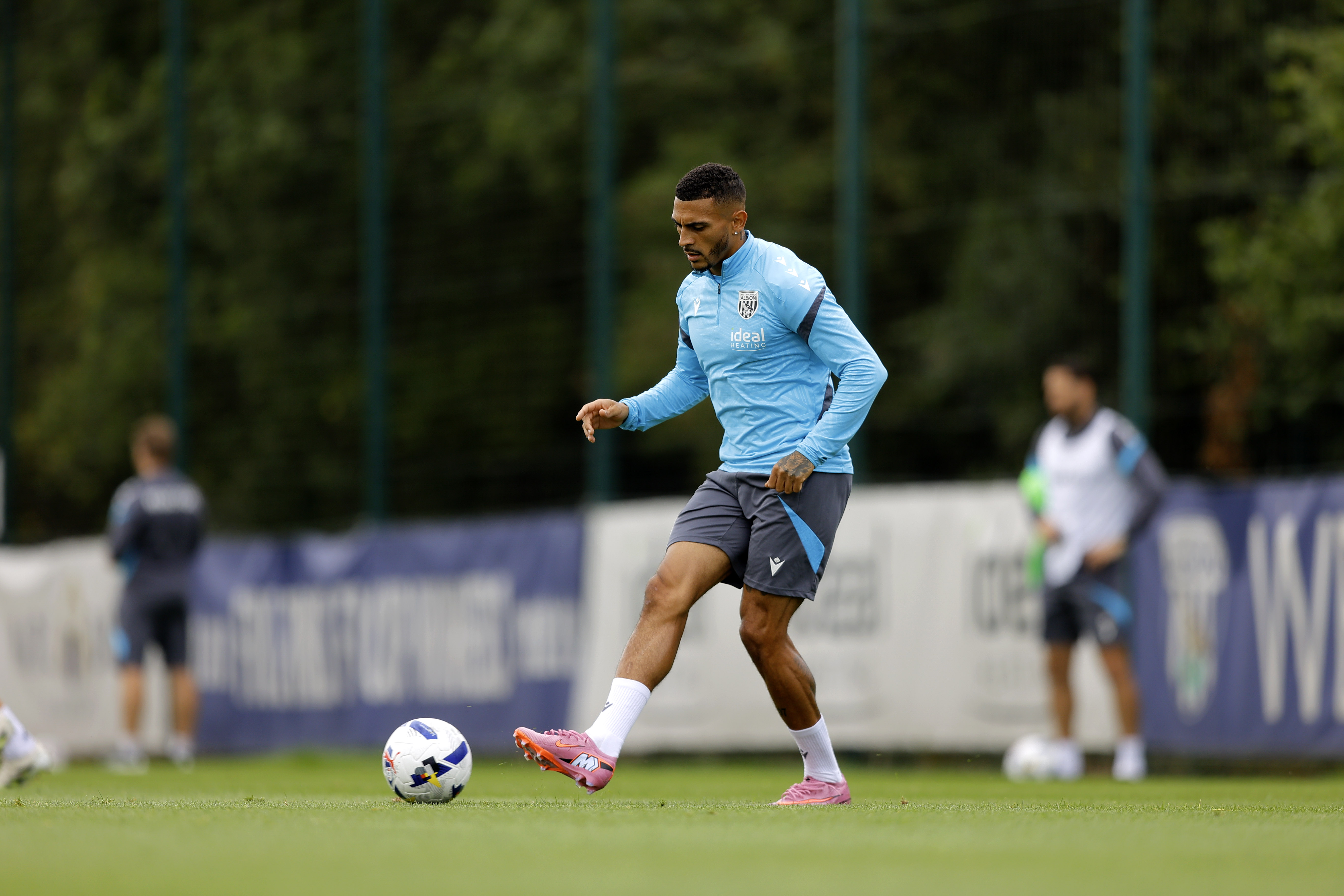 Karlan Grant passing the ball during training