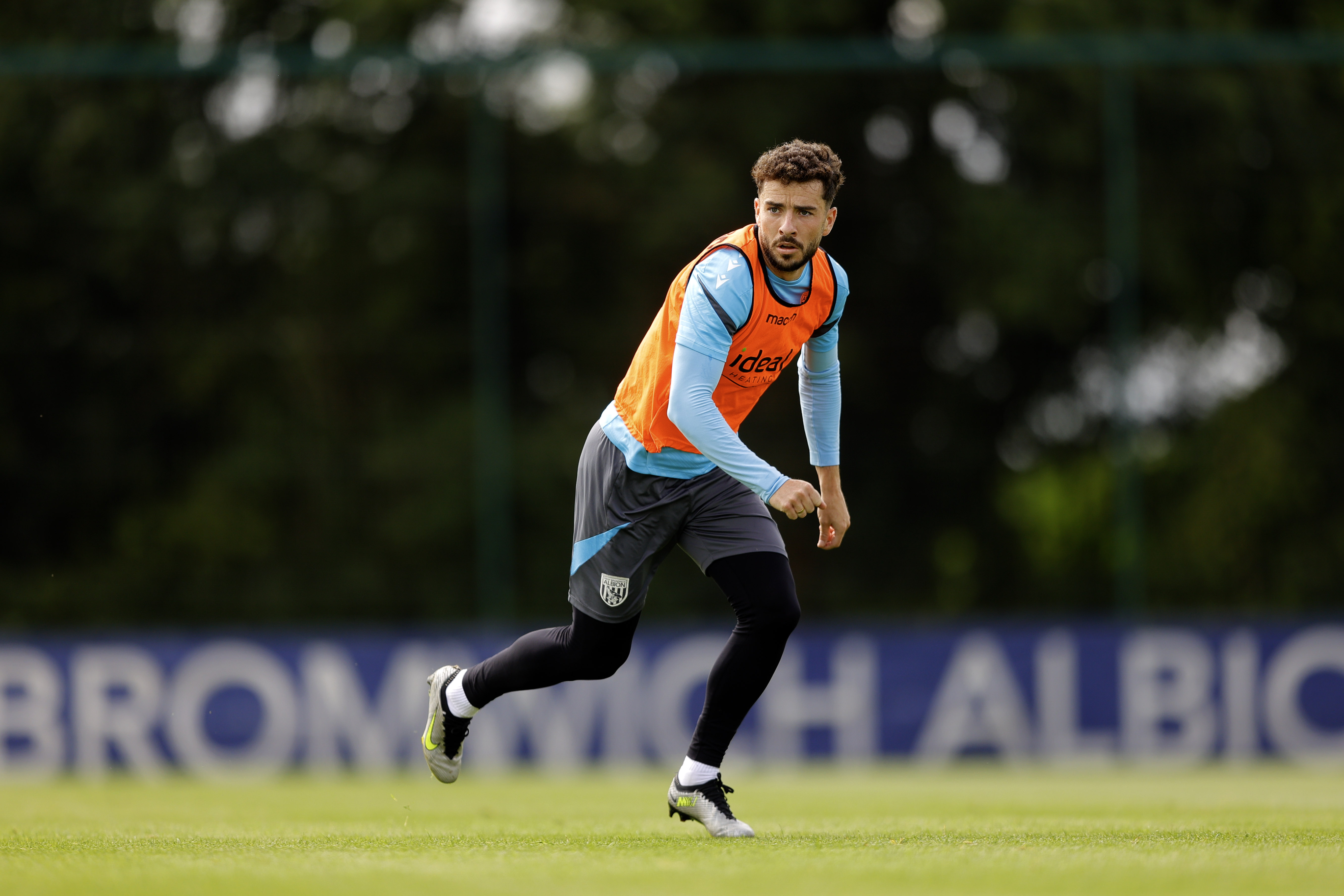 Mikey Johnston running forward looking for the ball during training