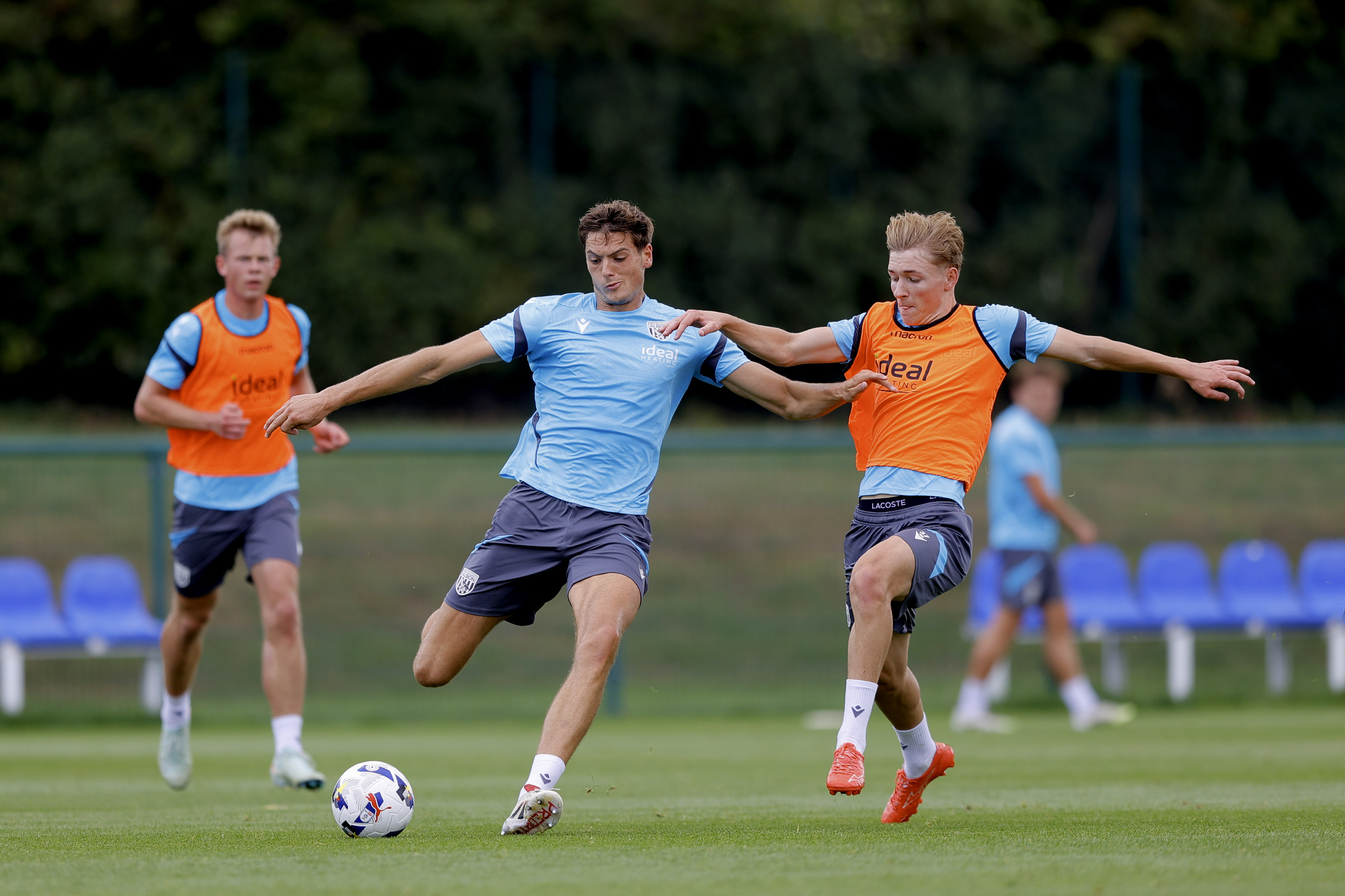 Caleb Taylor on the ball during a training session, under pressure from Ollie Bostock 