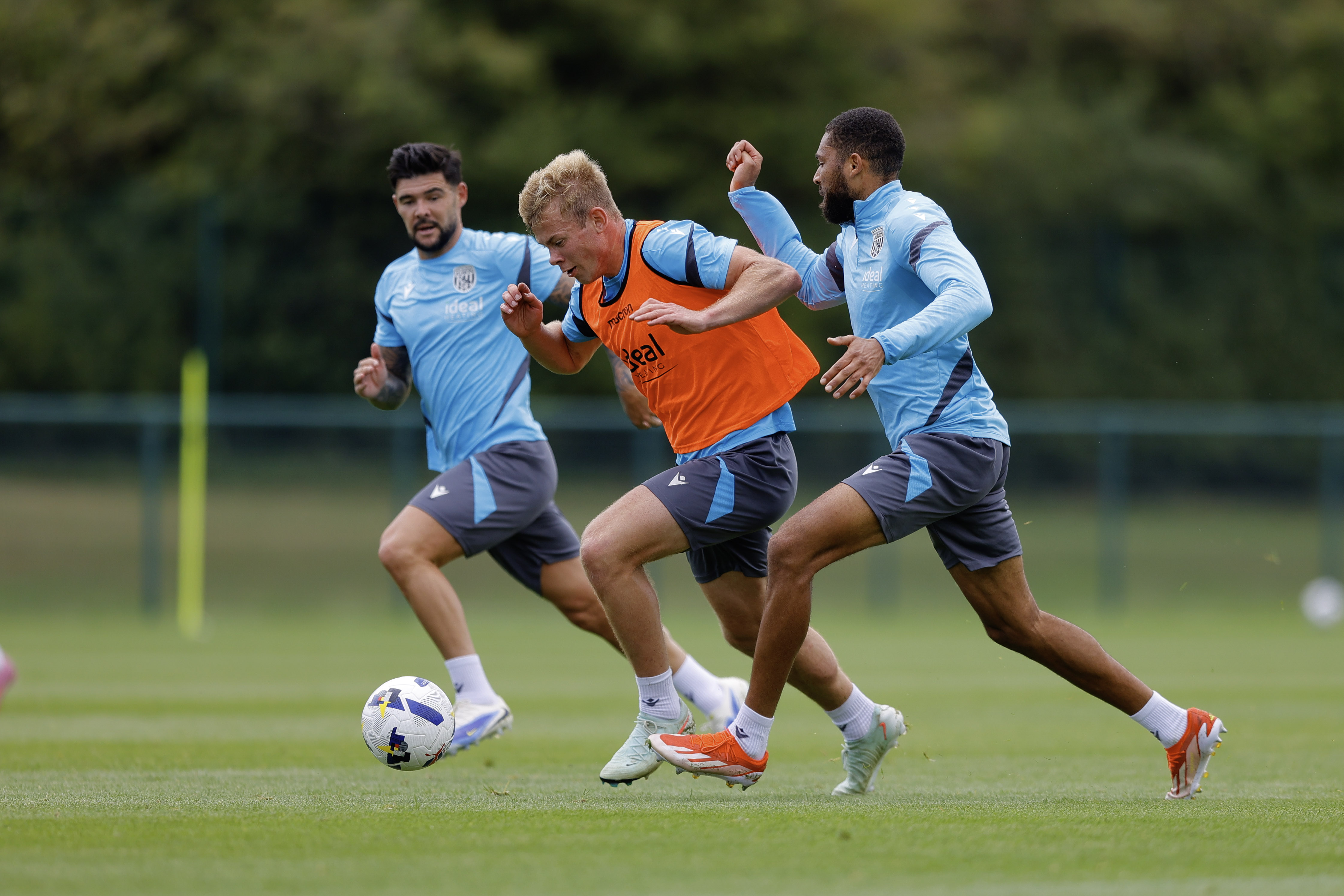 Aune Heggebø on the ball during training, under pressure from George Campbell