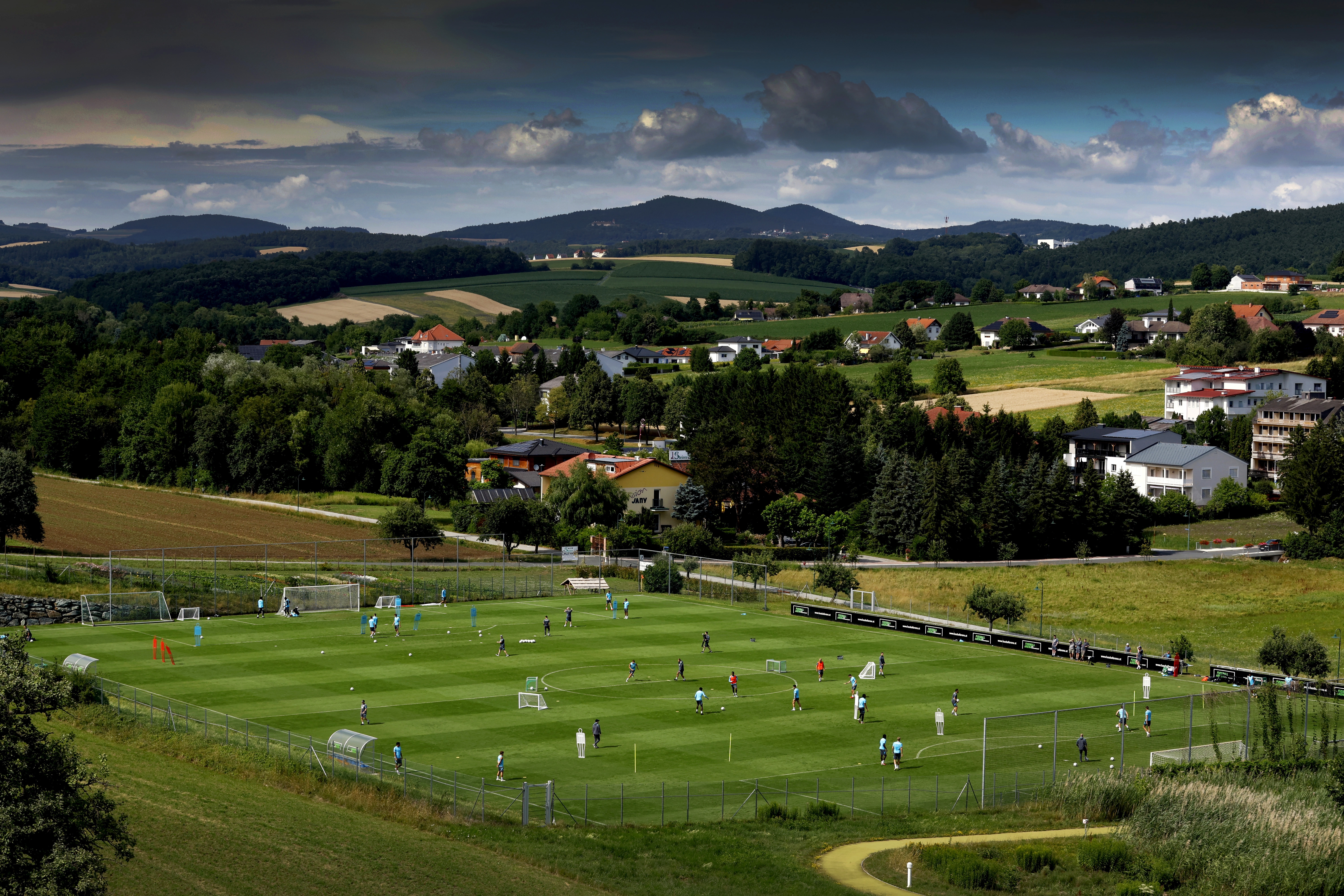 A general view of training from a vantage point with the pitch at the bottom of the hills