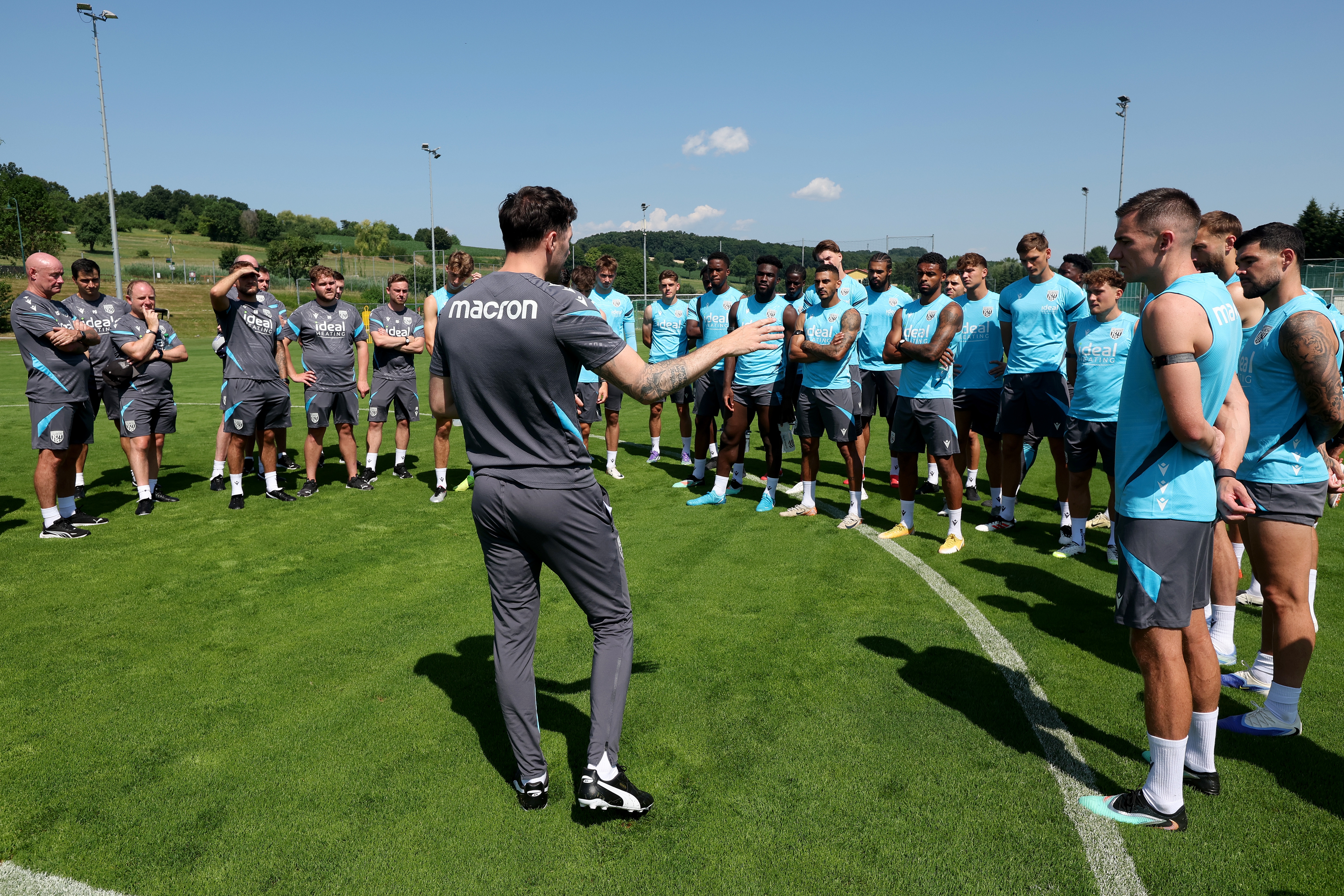 Ryan Mason addressing Albion players and staff on the training pitch before a session
