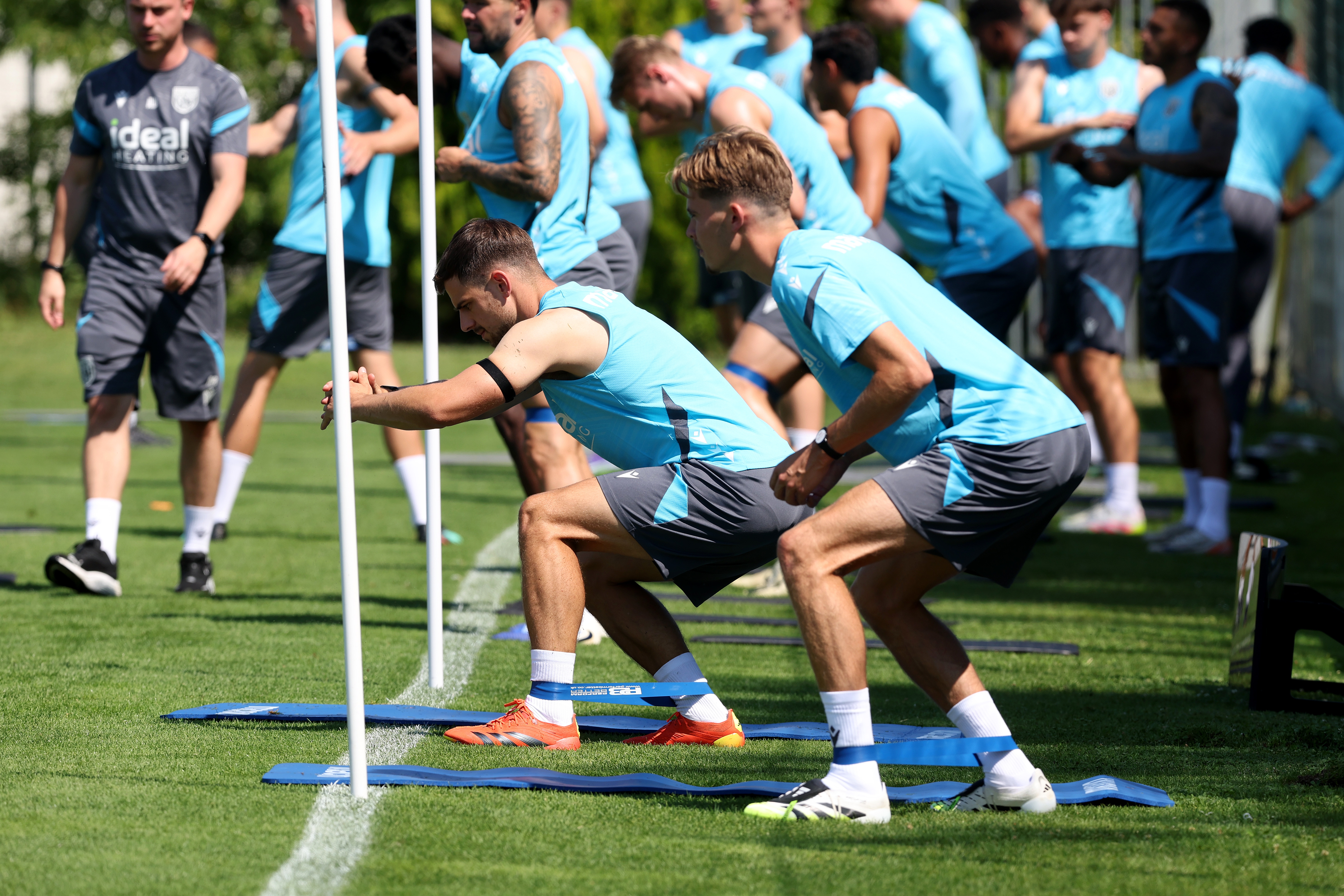 Several Albion players stretching before a training session