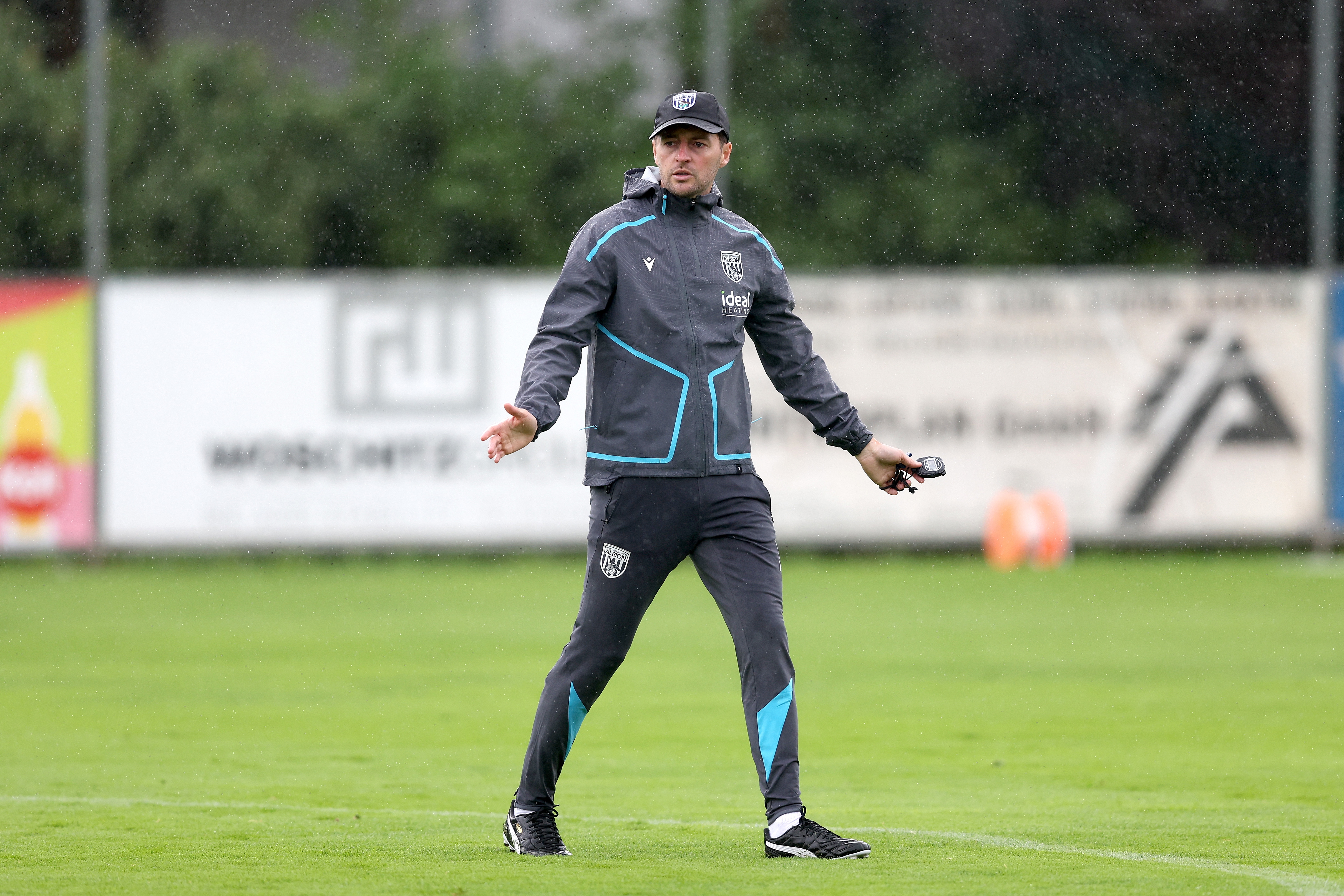 Ryan Mason coaching during a training session in the rain