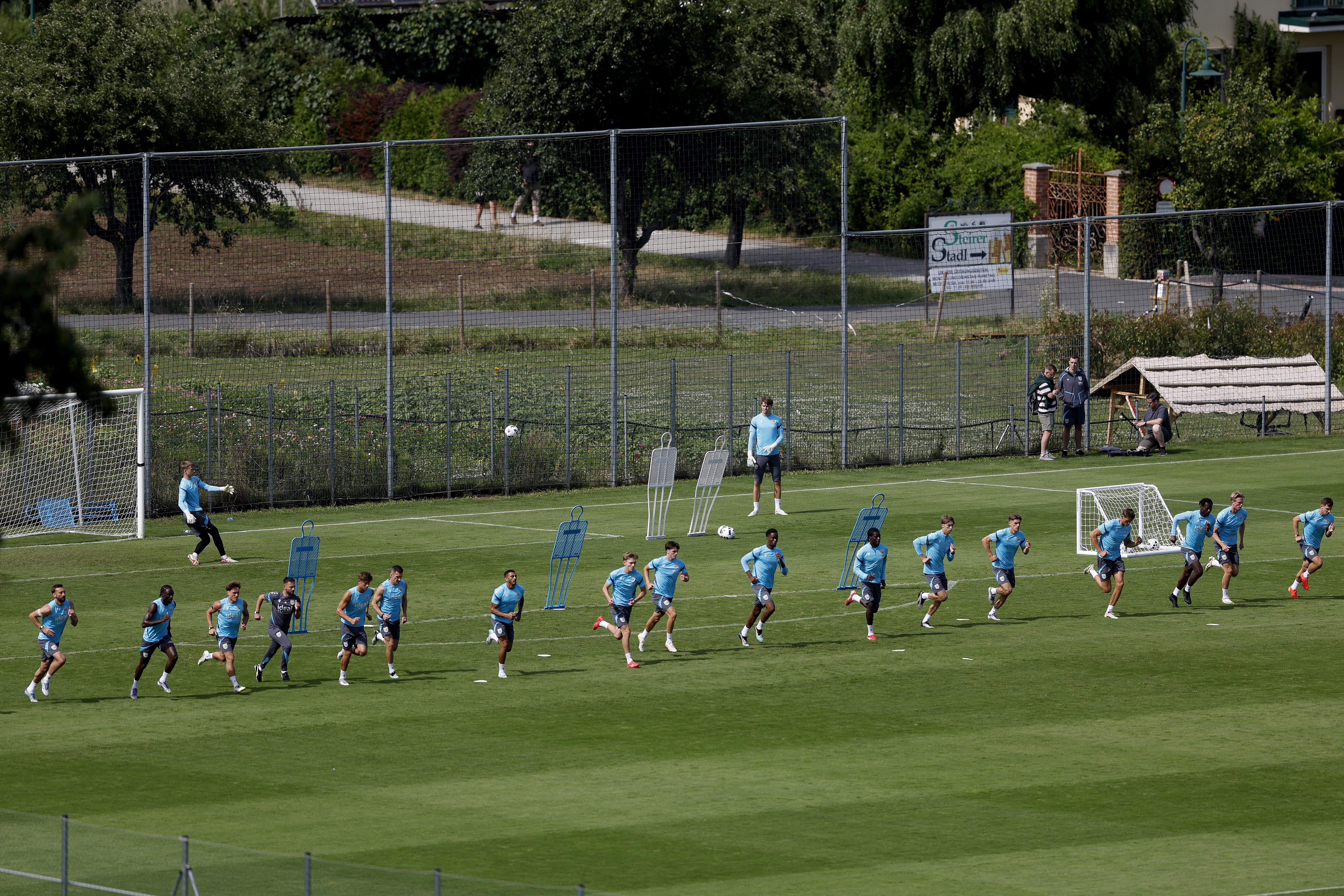 A general view of training from a vantage point with the pitch at the bottom of the hills