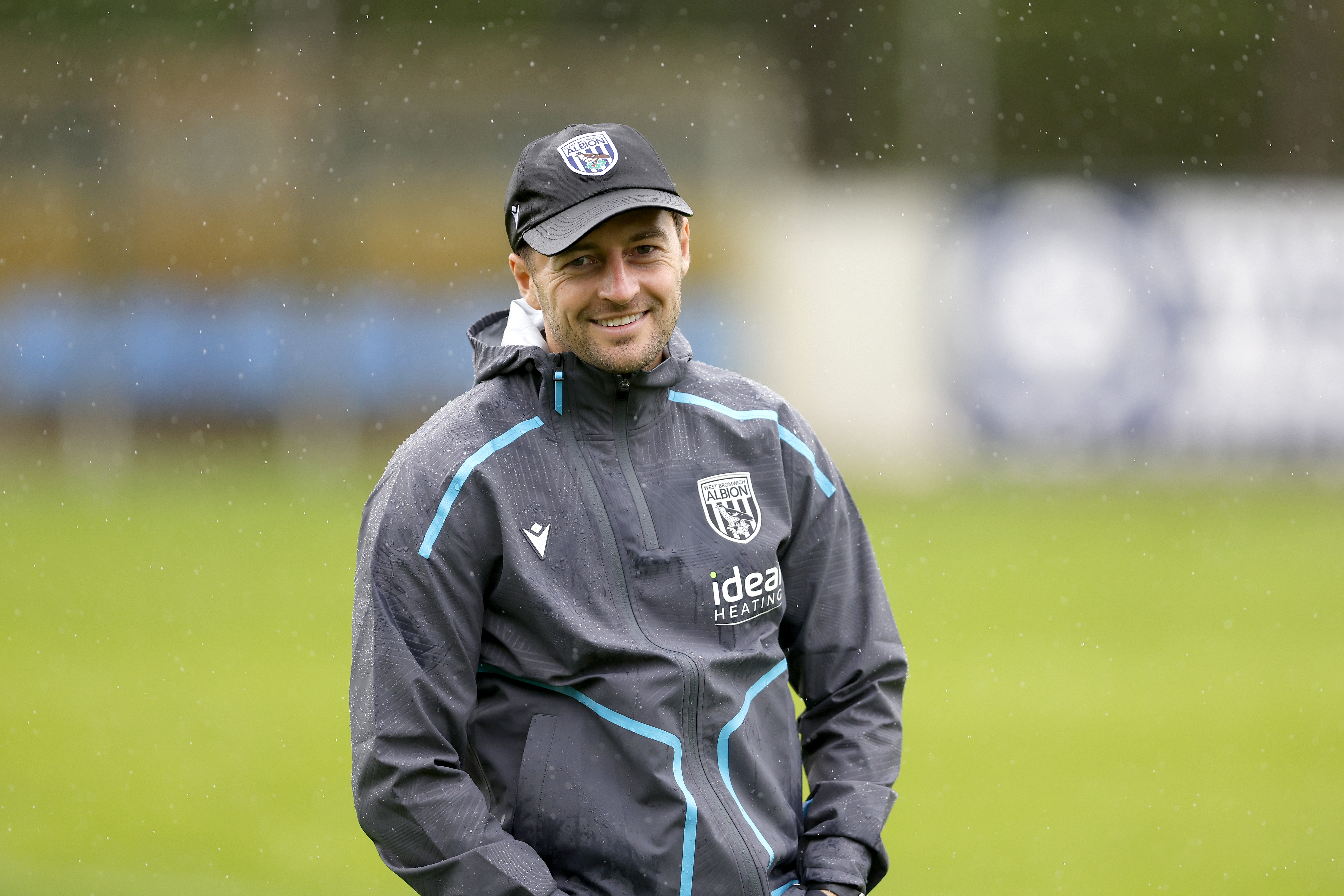 Ryan Mason smiling during a training session while wearing a cap