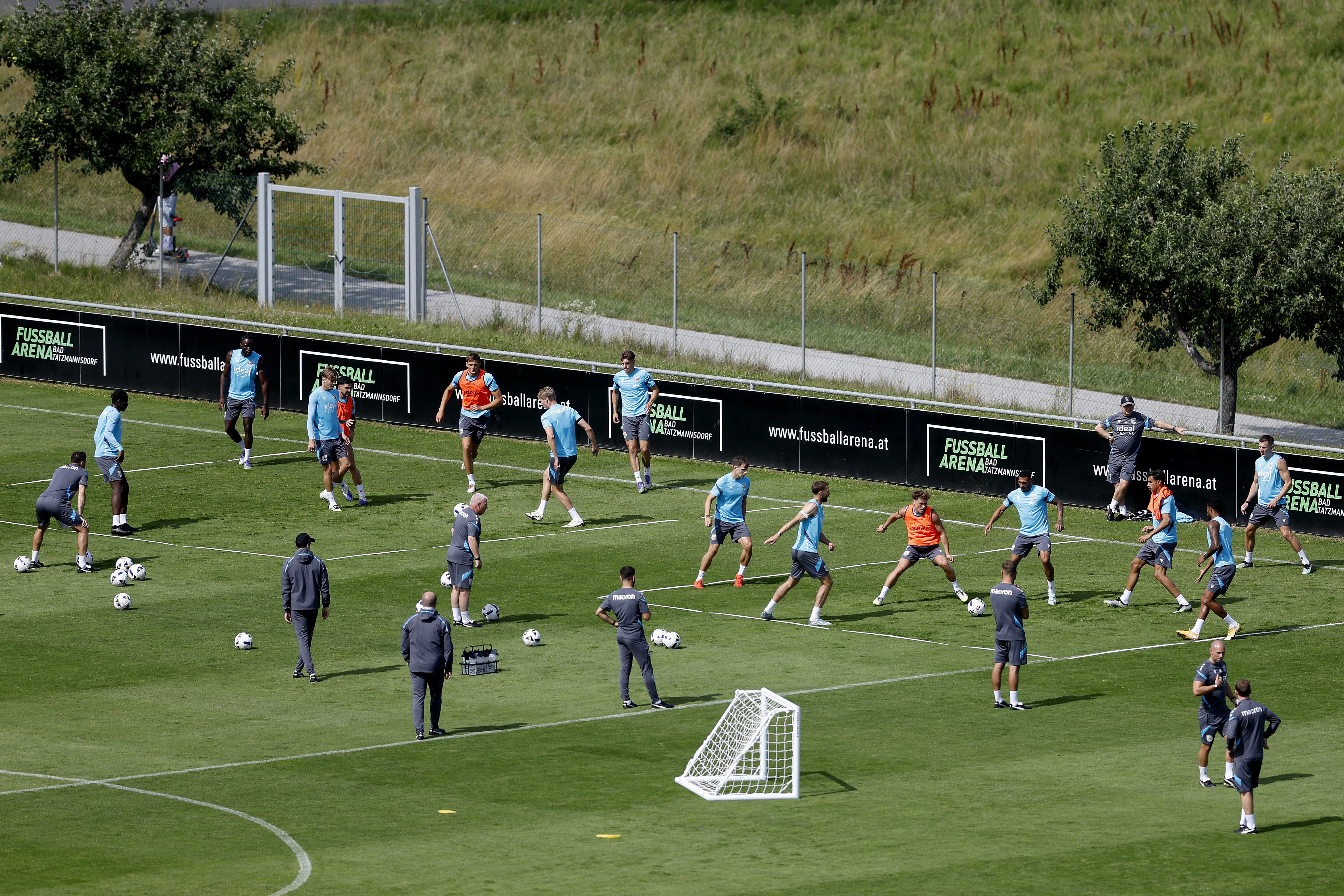 A general view of training from a vantage point with the pitch at the bottom of the hills