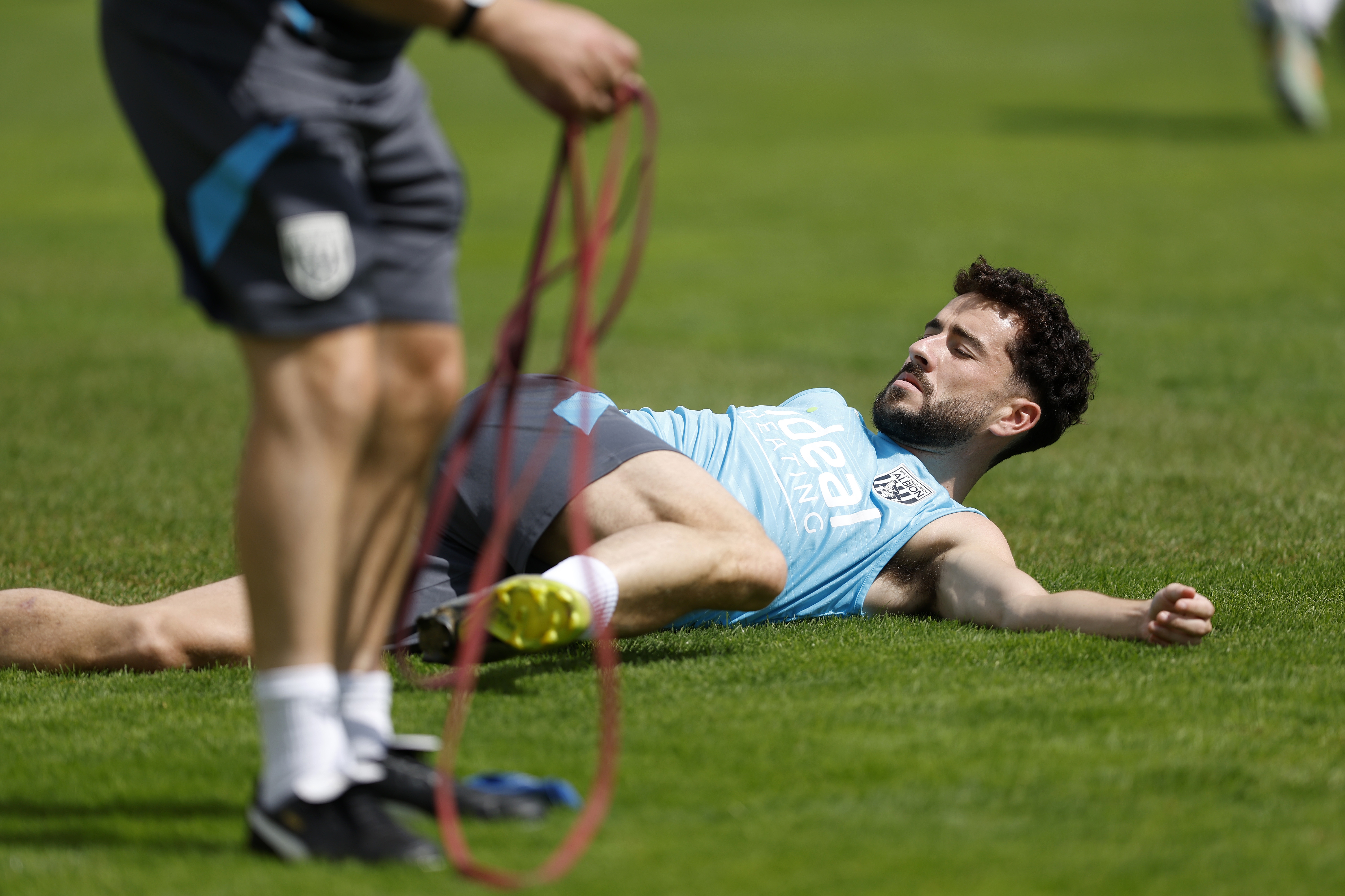 Mikey Johnston stretching during a training session in Austria