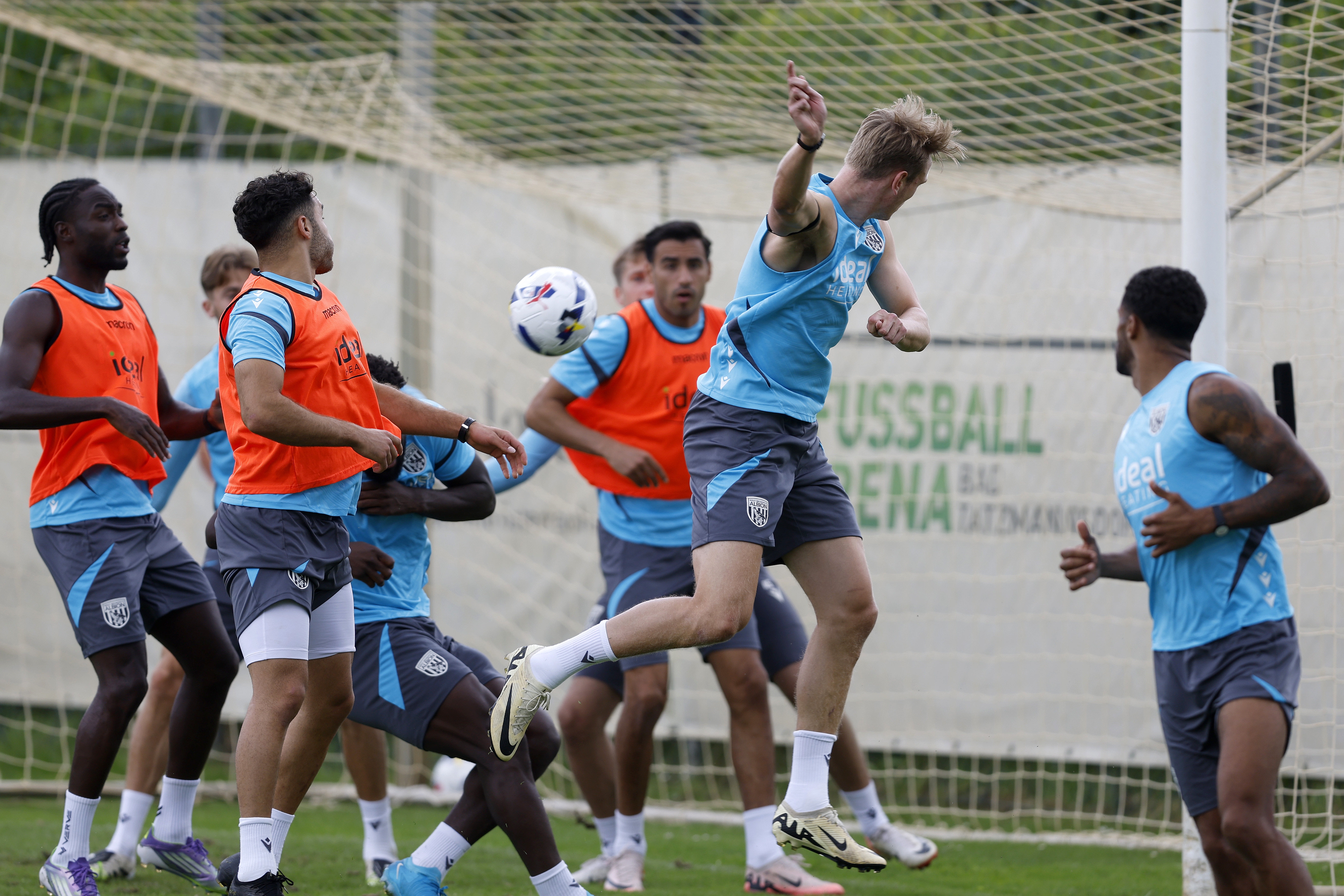 Several players in the penalty area jumping to try and win a header during a training session in Austria 