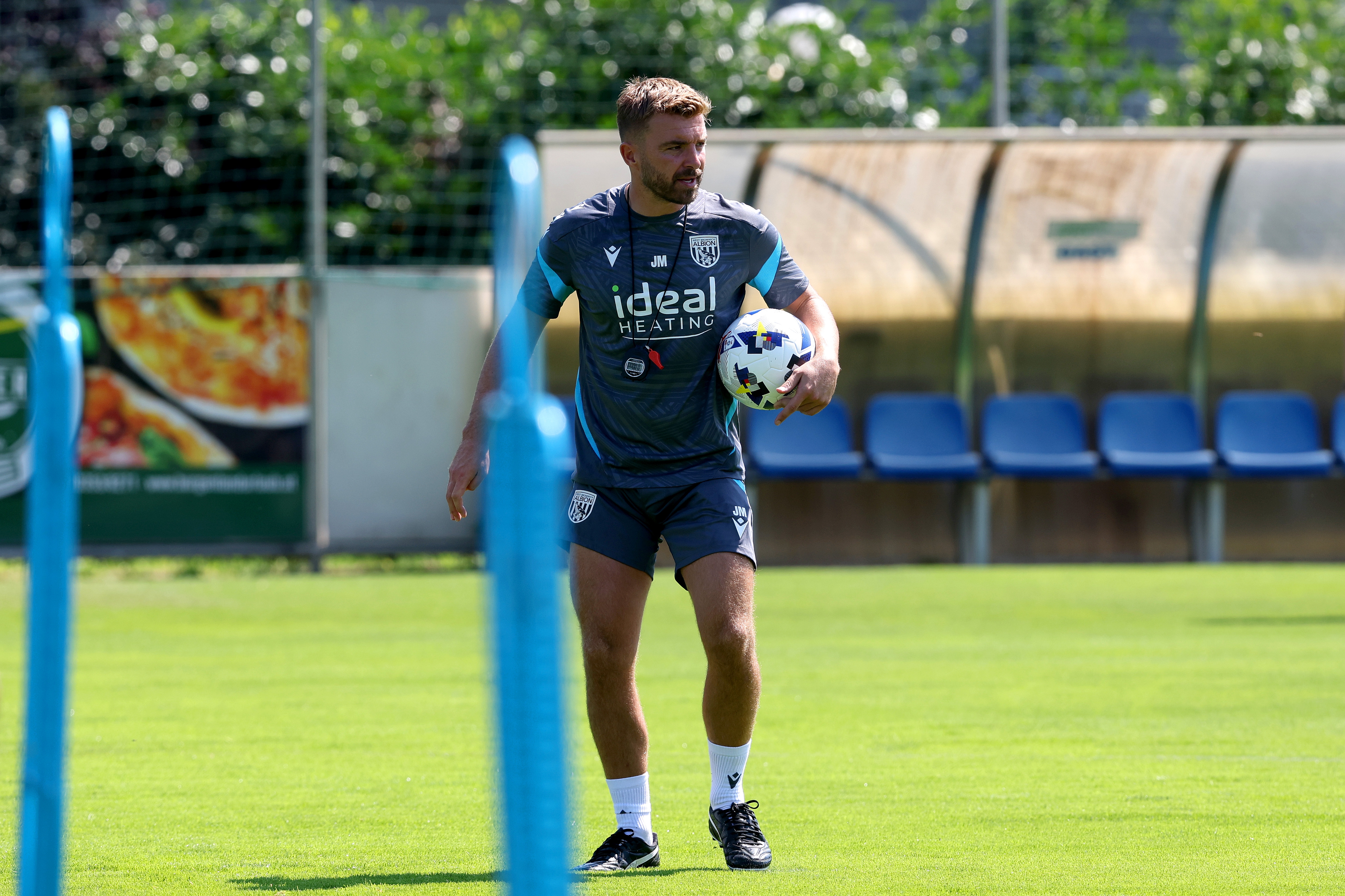 James Morrison watching a training session in Austria while holding a ball