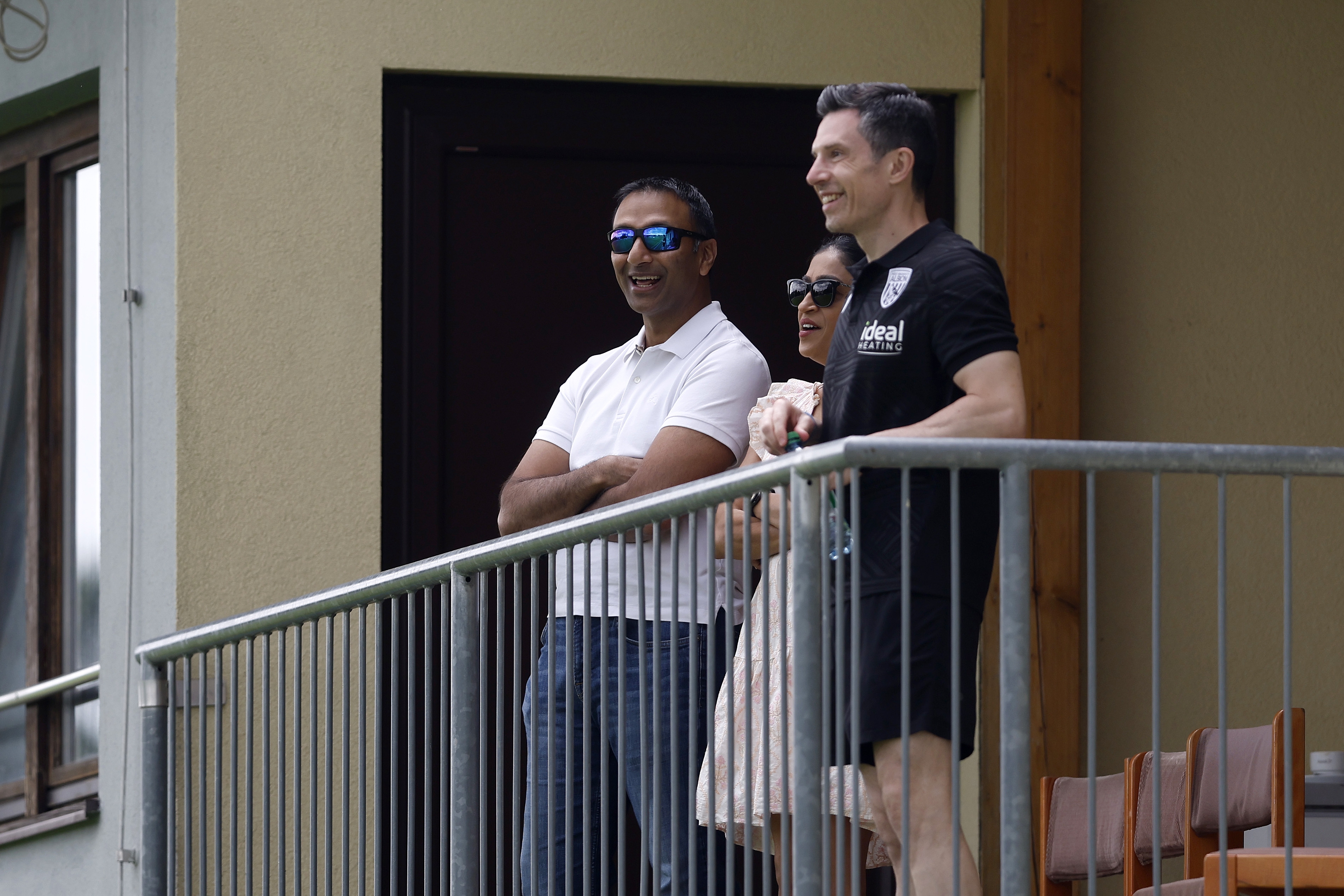 Shilen Patel and Andrew Nestor smiling while watching Albion play Dynamo Kyiv