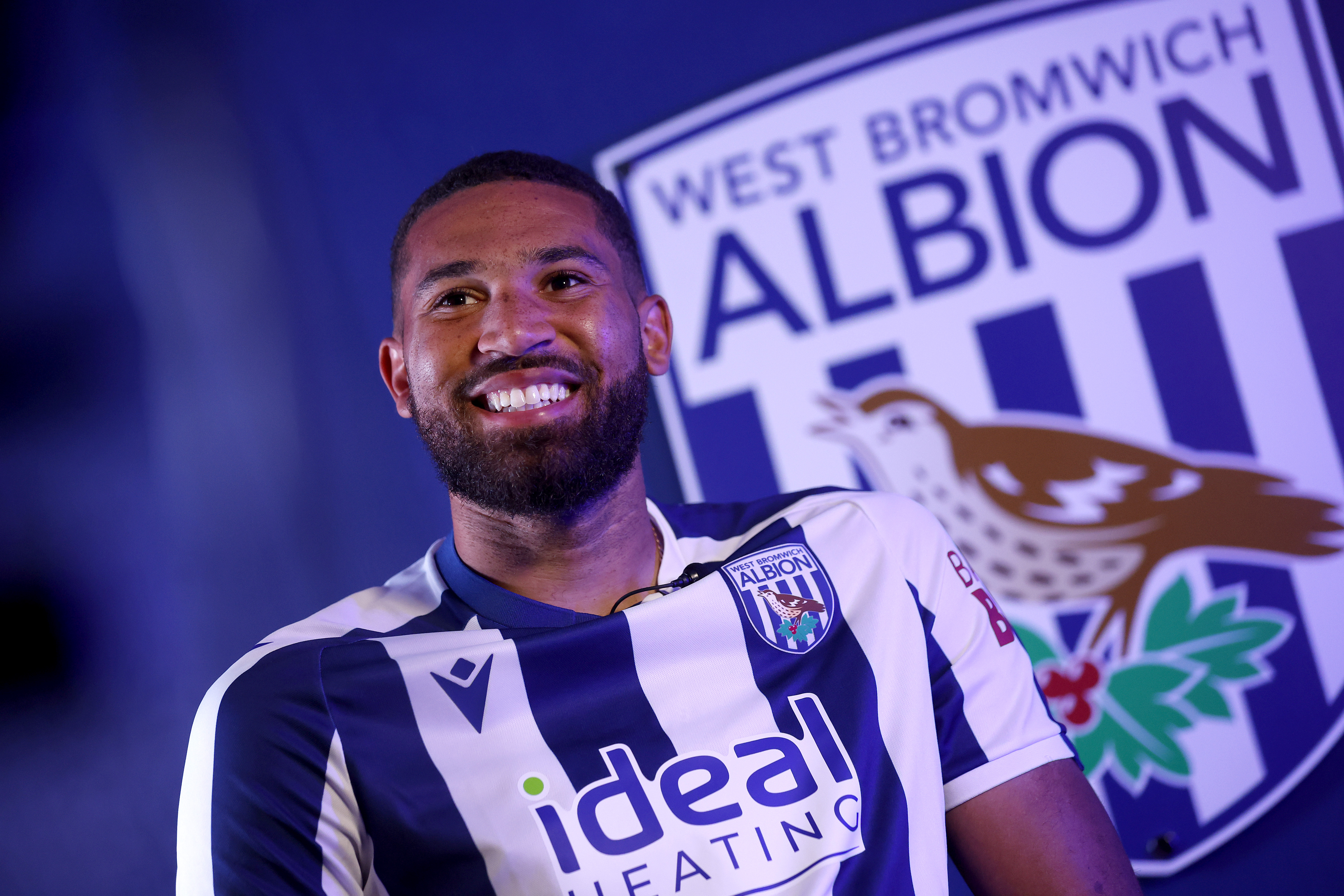 George Campbell smiling while sat in a WBA home shirt and being interviewed by WBA TV
