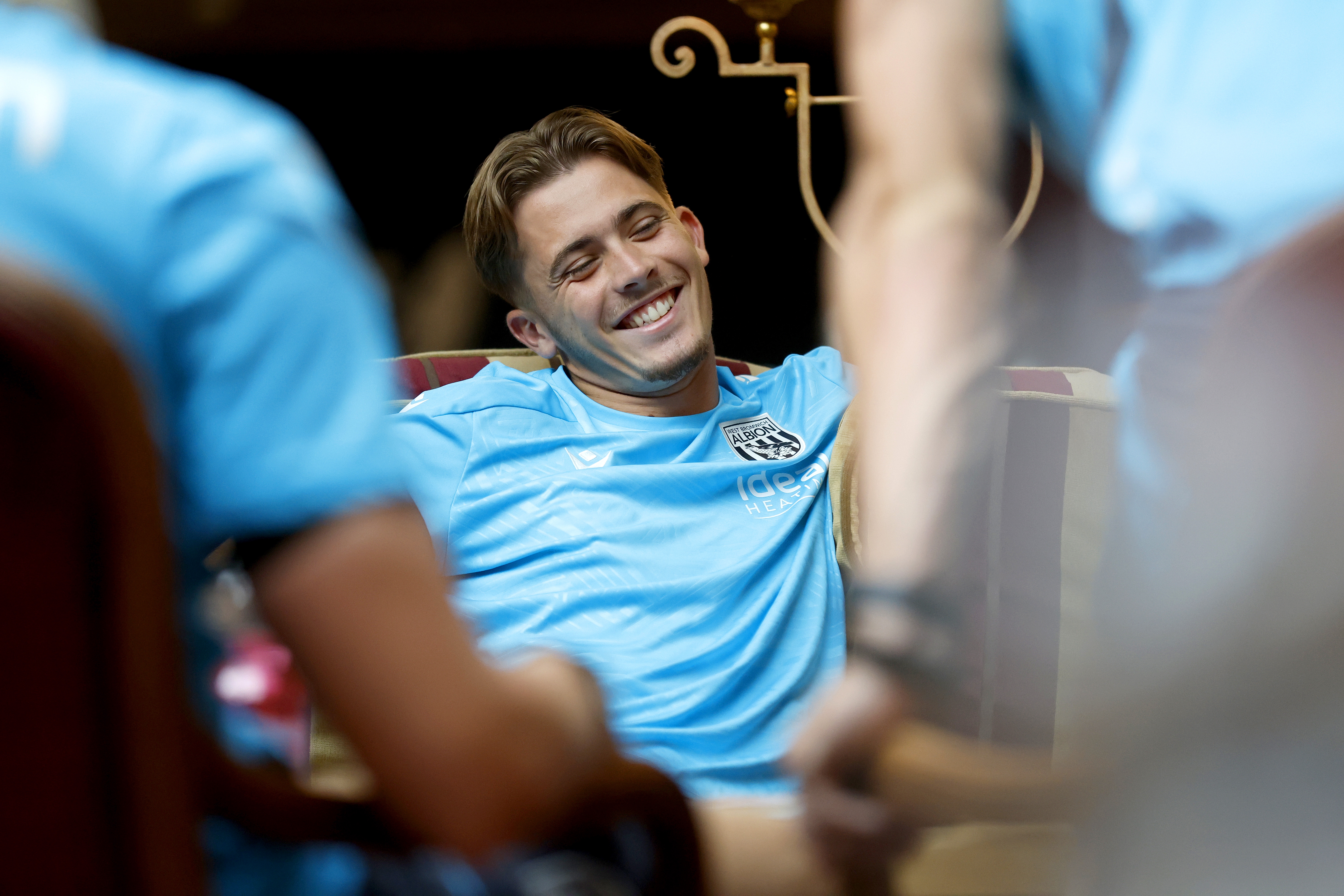Isaac Price smiling while playing cards