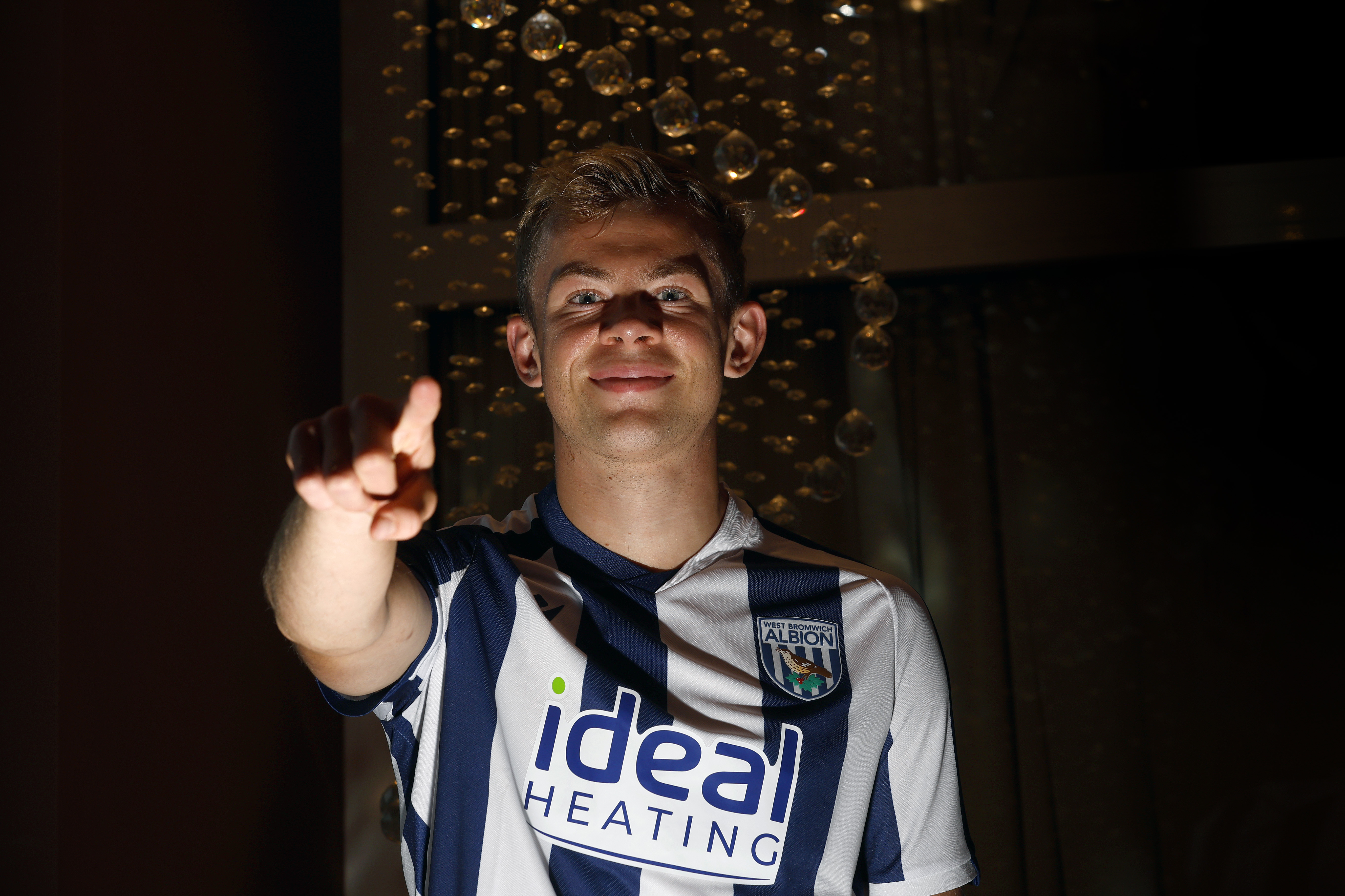 Aune Heggebø smiling and pointing at the camera while in a WBA shirt