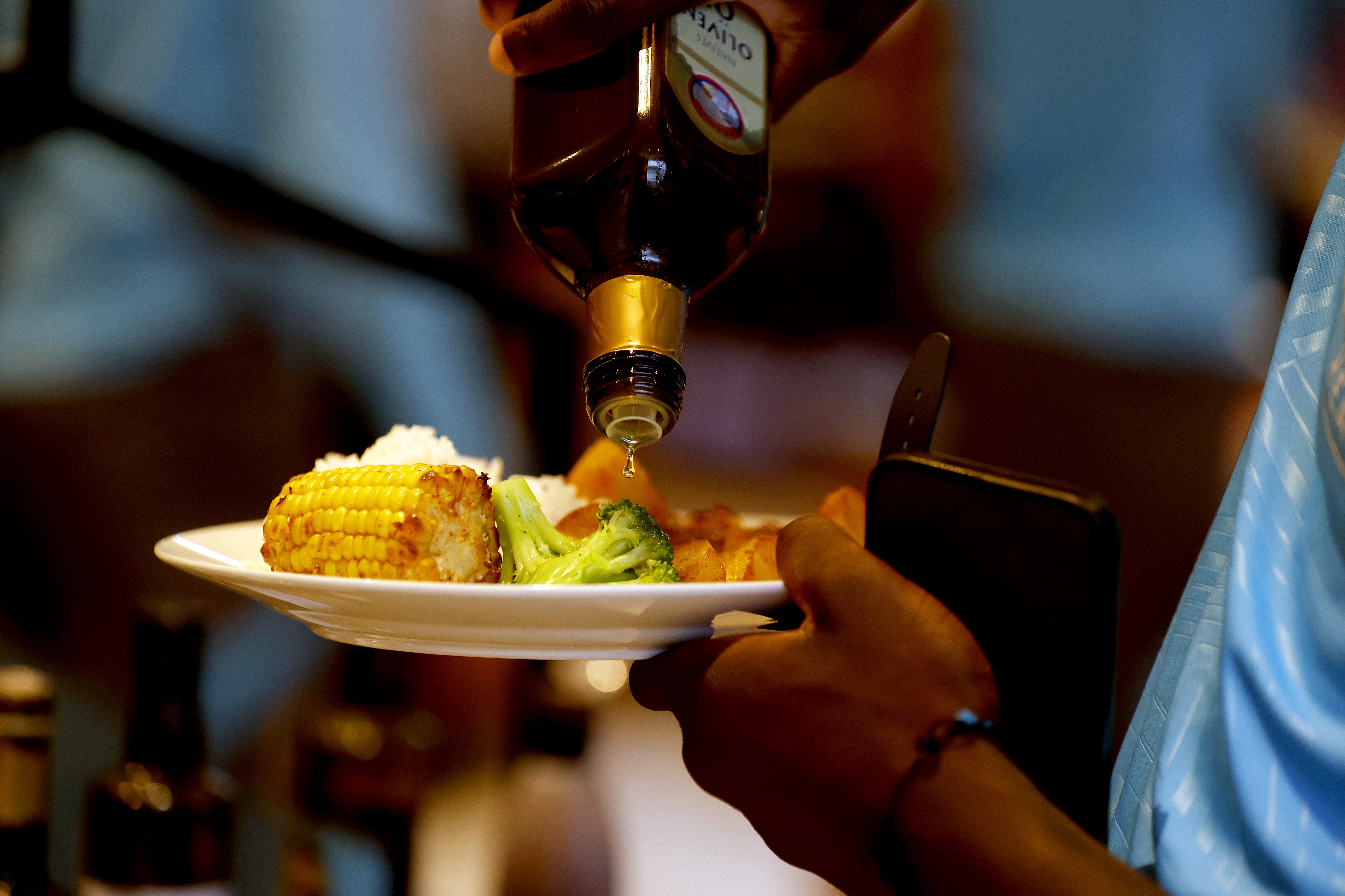 Olive oil being poured on a dinner 