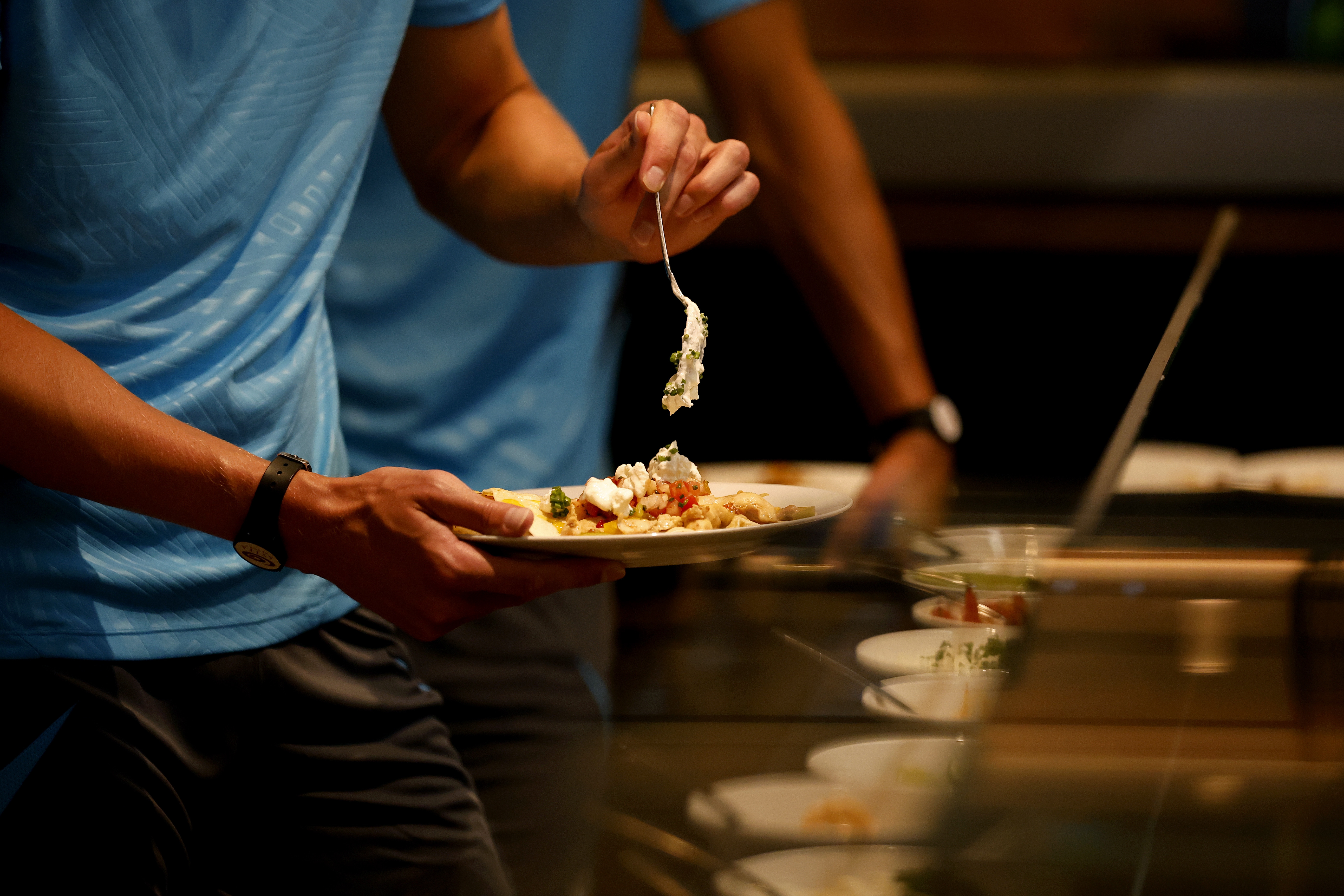 A player placing food on his plate 