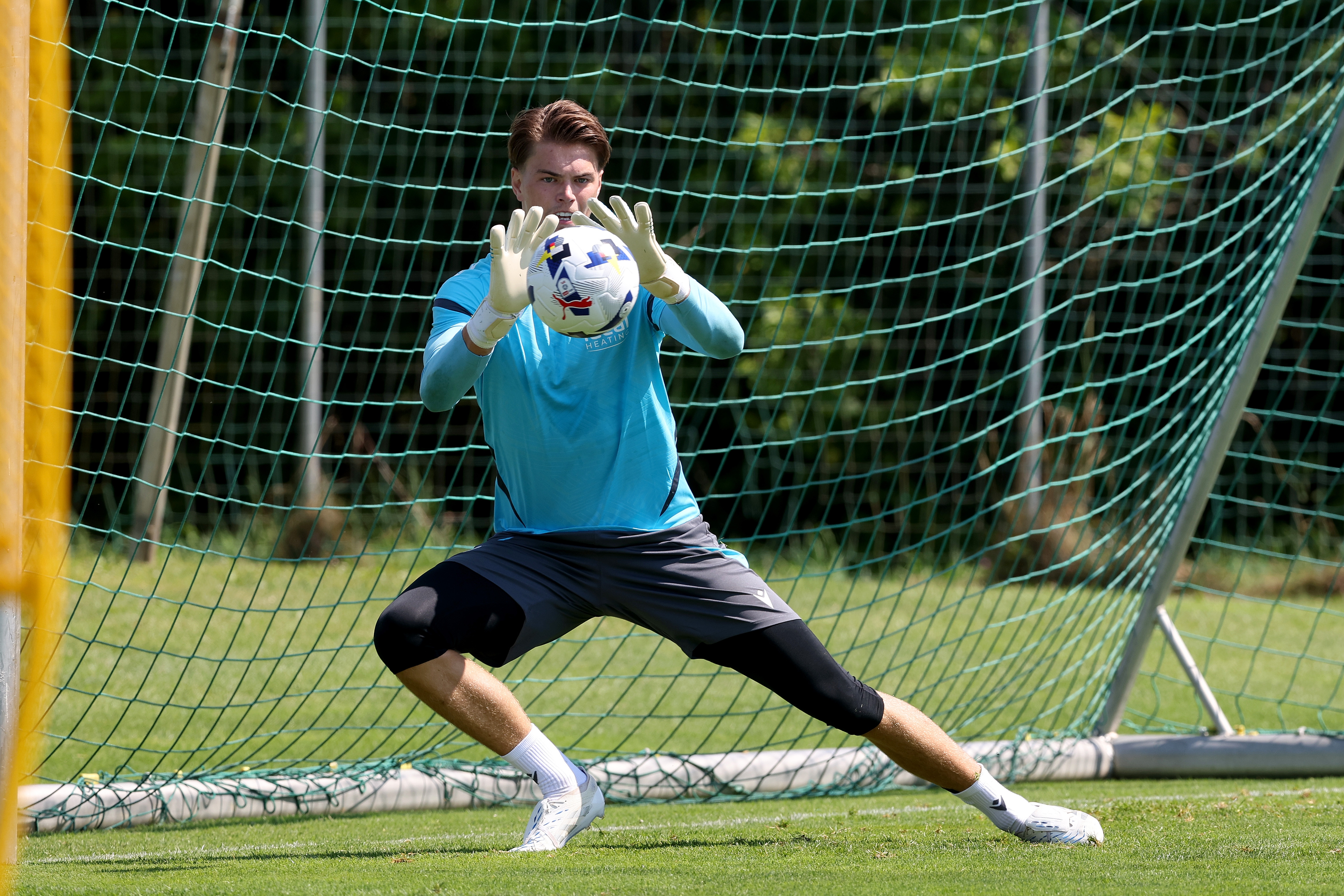 Josh Griffiths saving a shot during a training session