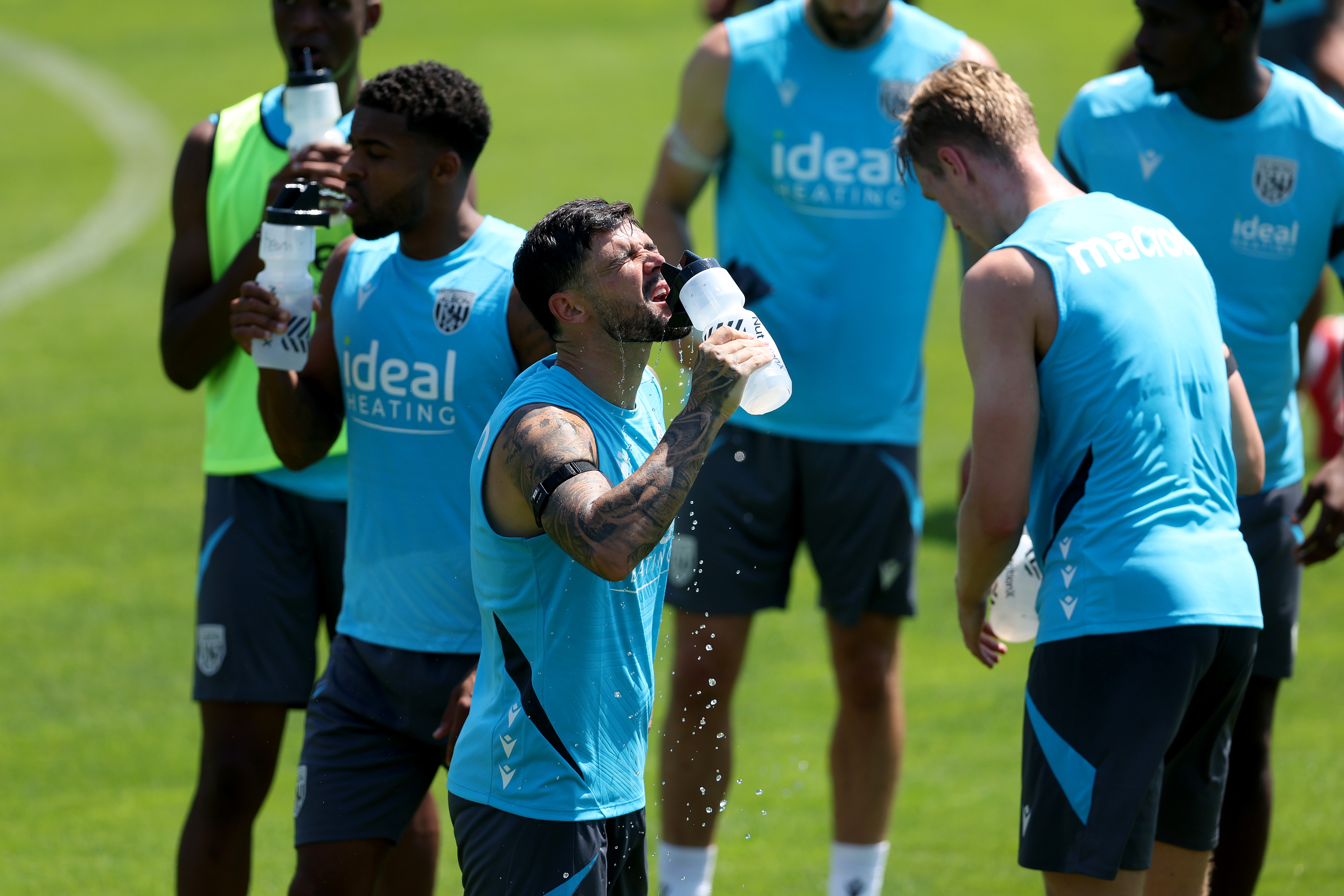 Alex Mowatt and Darnell Furlong drinking water during a training session
