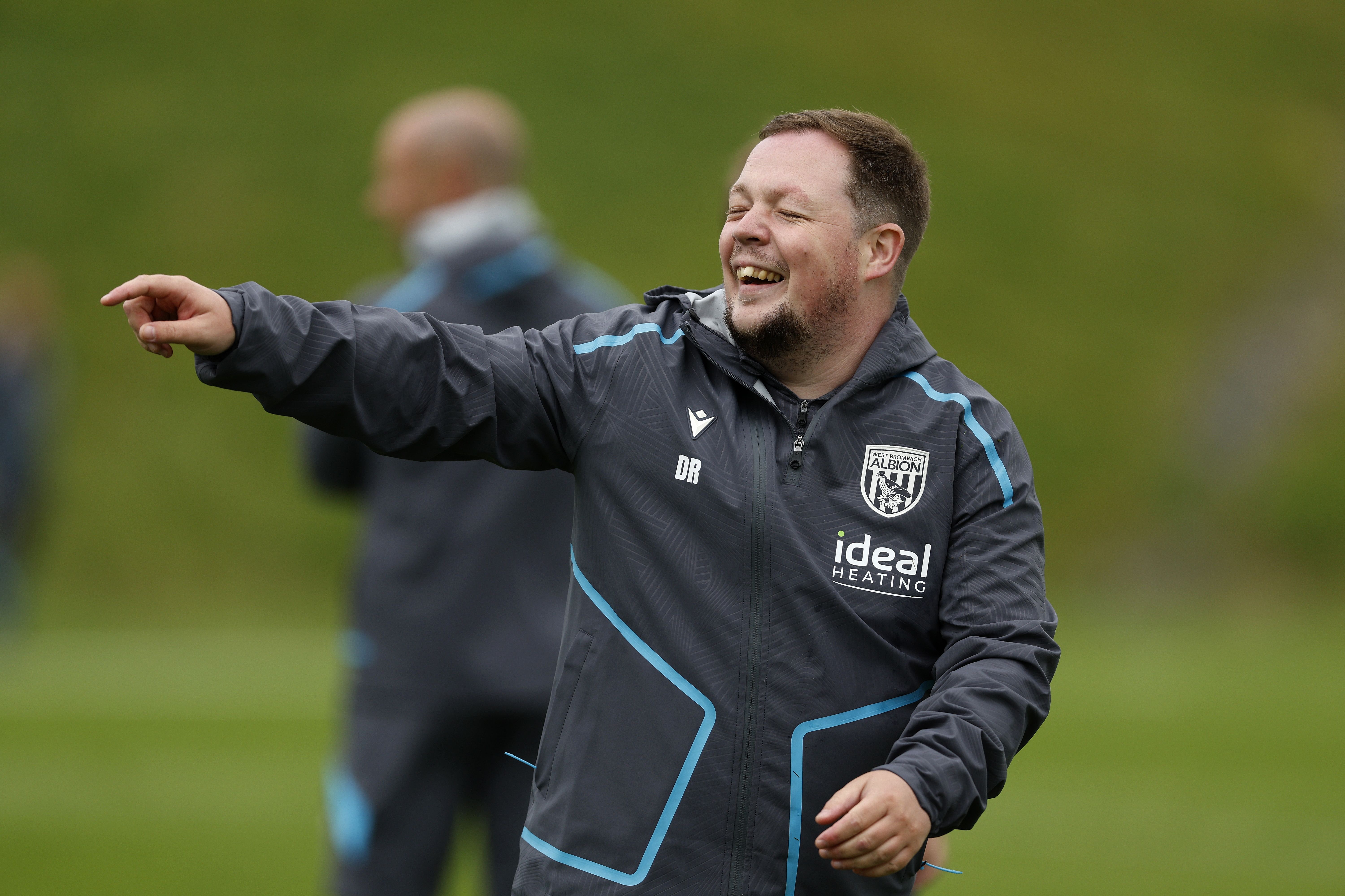 Albion medical staff member Dave Rafferty smiling and pointing on the training pitch 