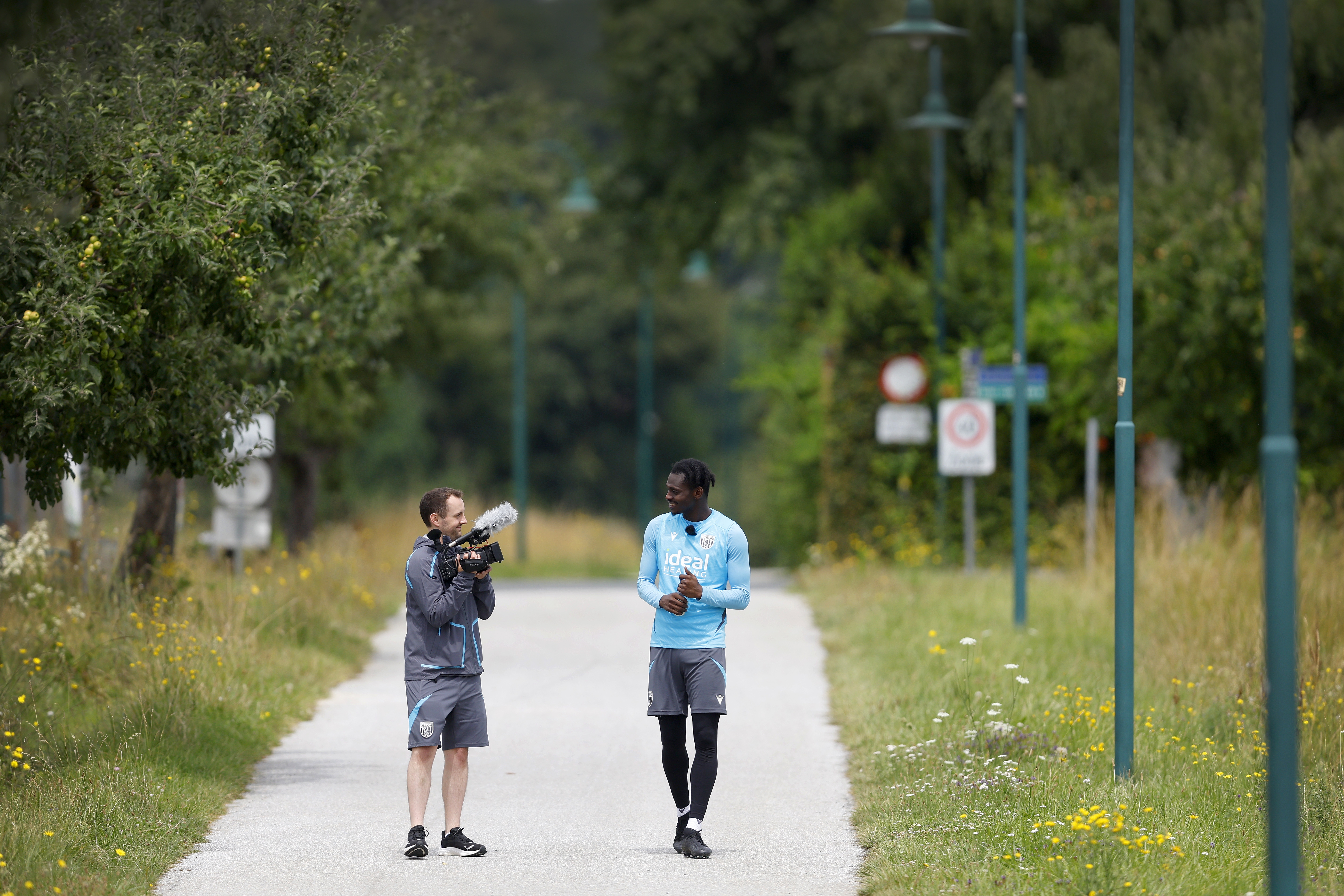 Albion cameraman Joe Shepherd filming Ousmane Diakité on a long path in Austria 