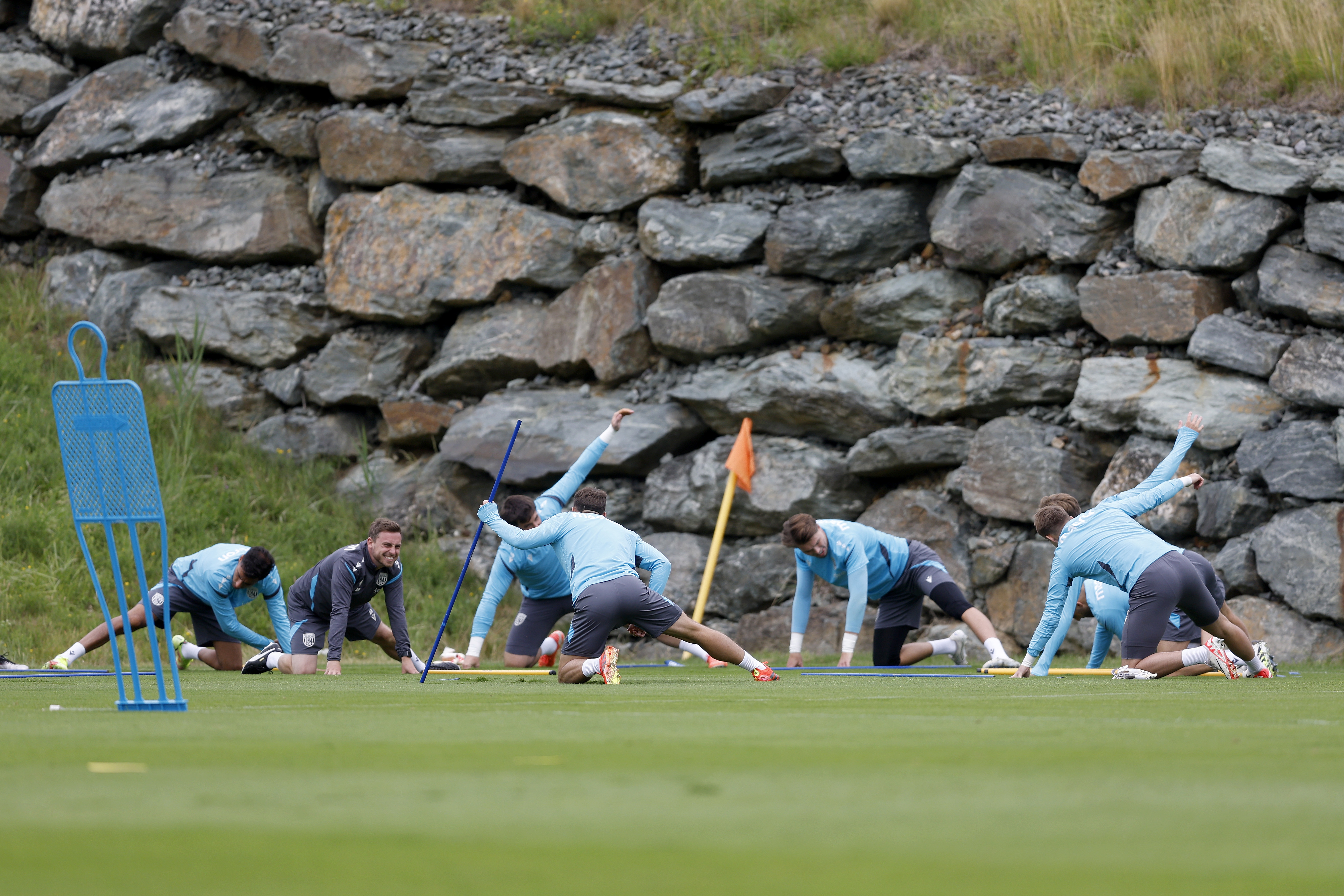Albion goalkeepers warming up in front of several rocks