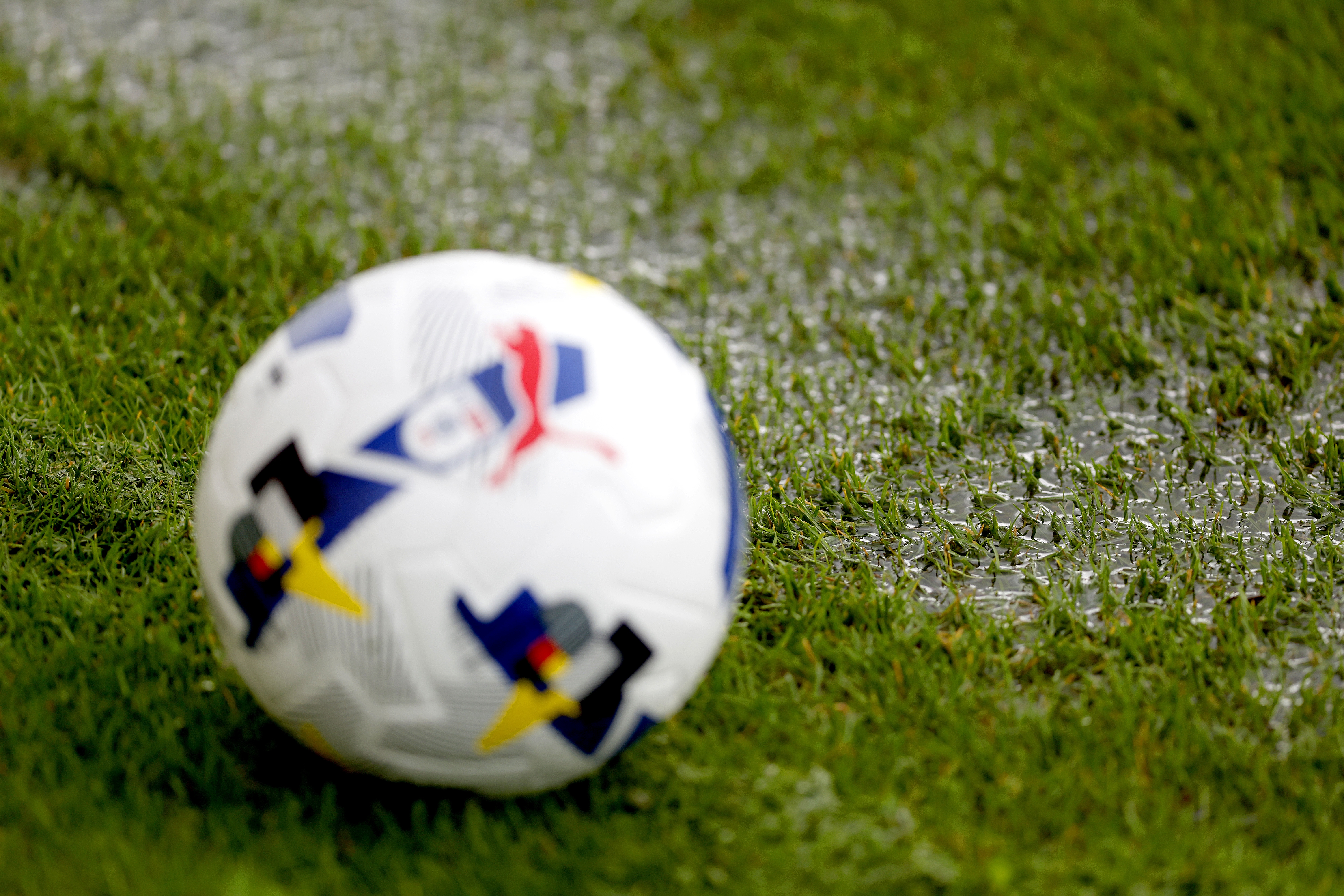 A general view of a rain puddle on the side of the pitch with a ball
