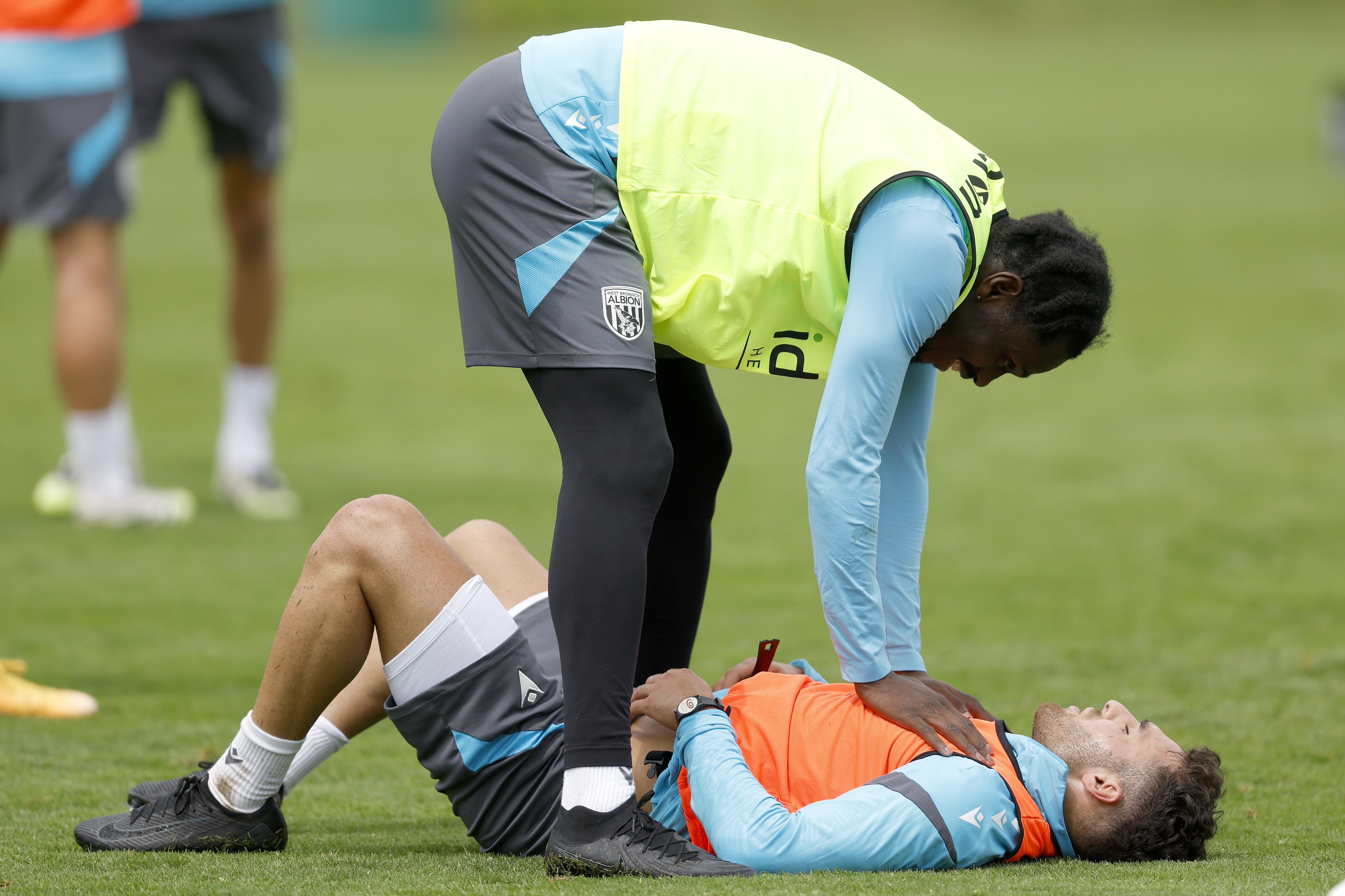 Tammer Bany lying on the ground and Ousmane Diakité standing over him during training 