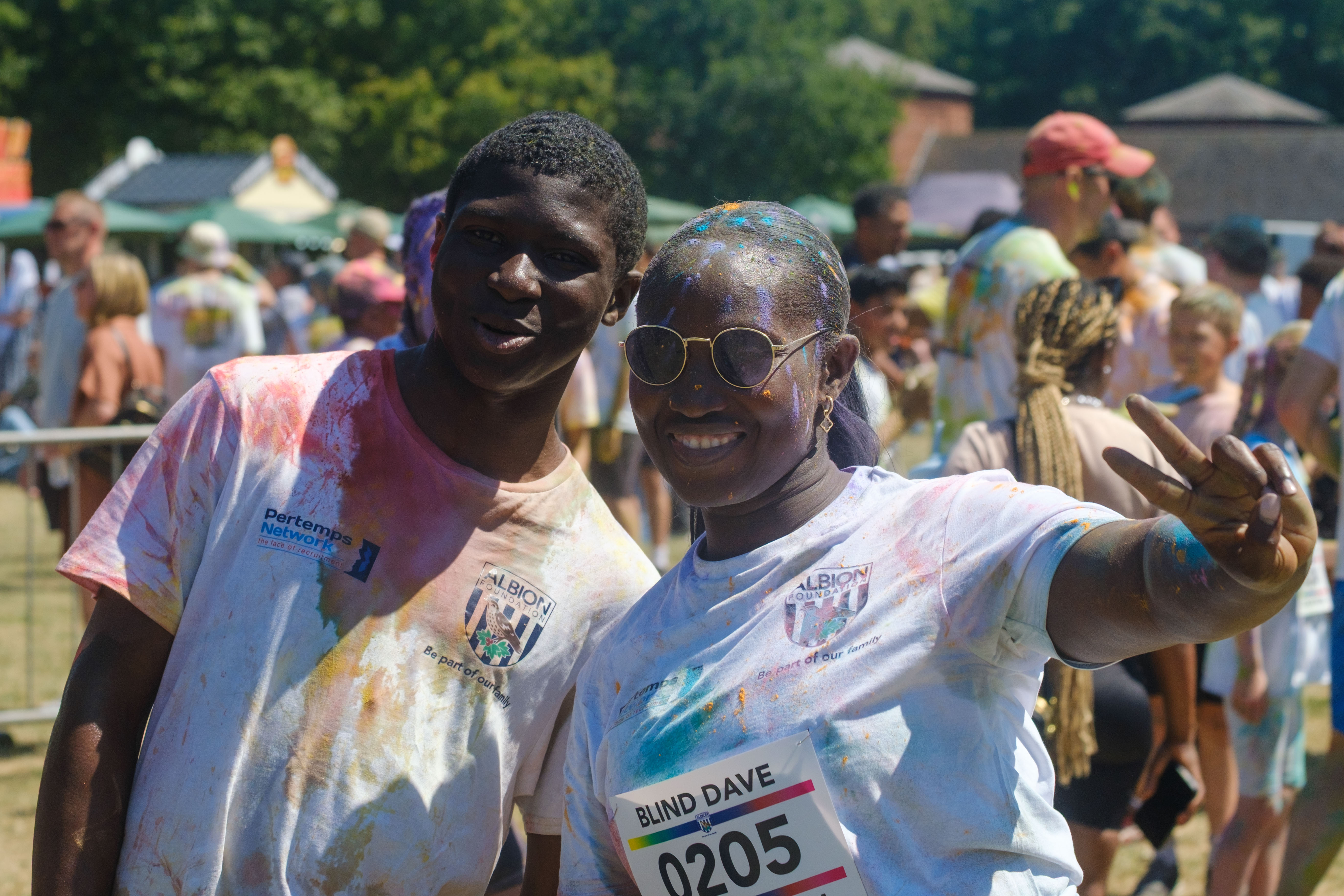 Two participants posing for a photo, one holding up the peace sign.