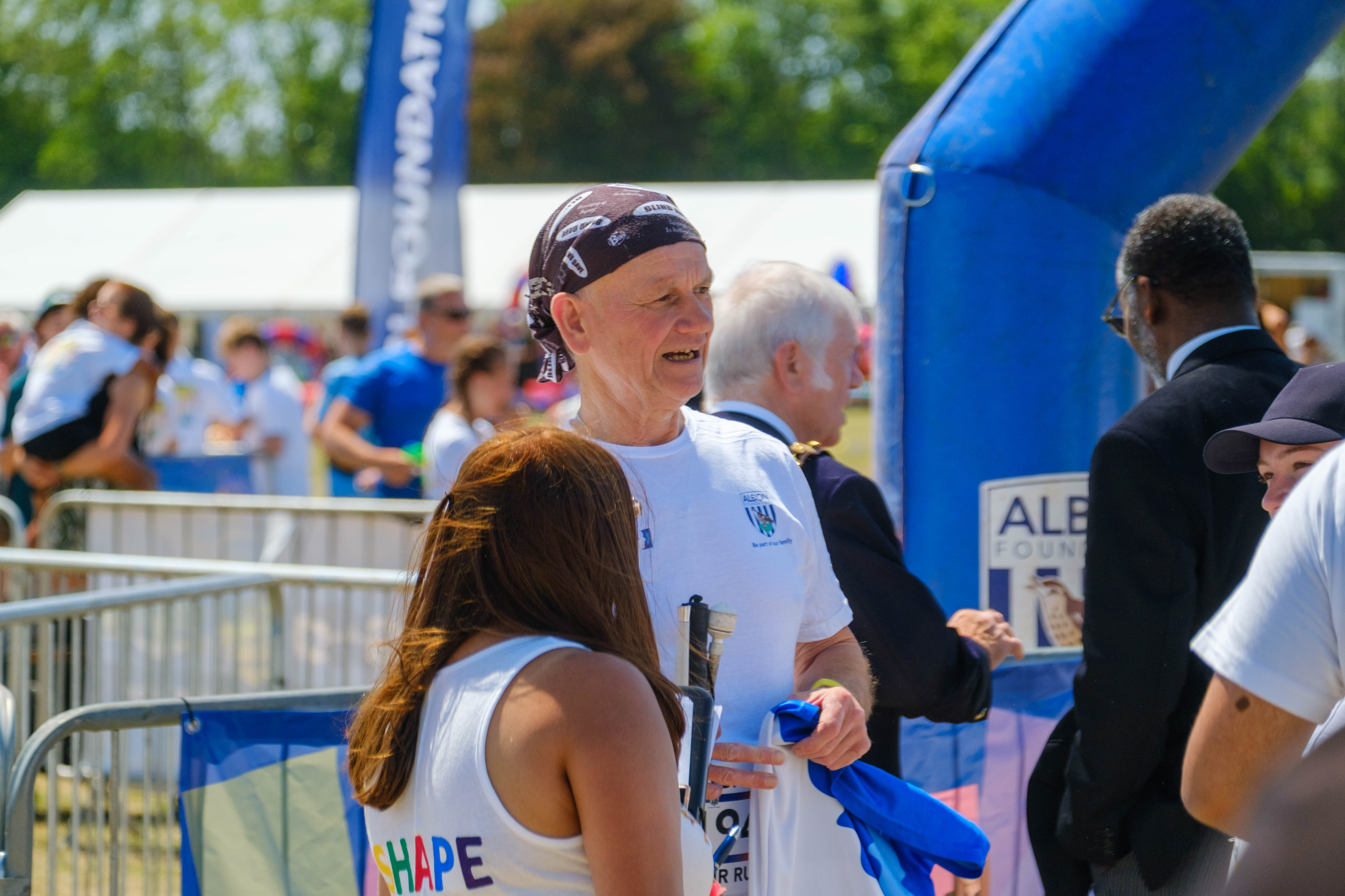 Blind Dave in conversation with a SHAPE festival staff member.