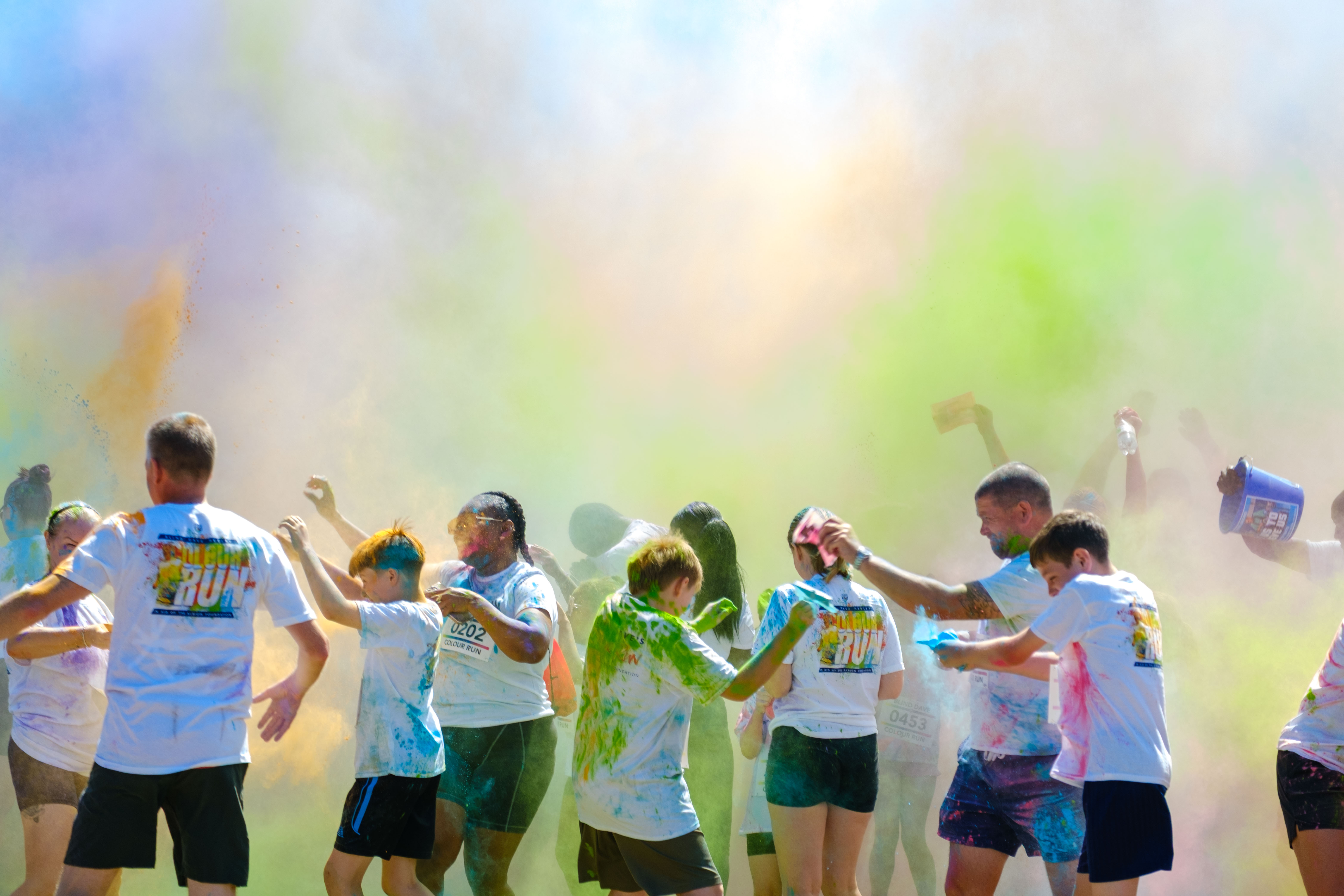 Cloud of colour after the paint throw, participants cover in paint.