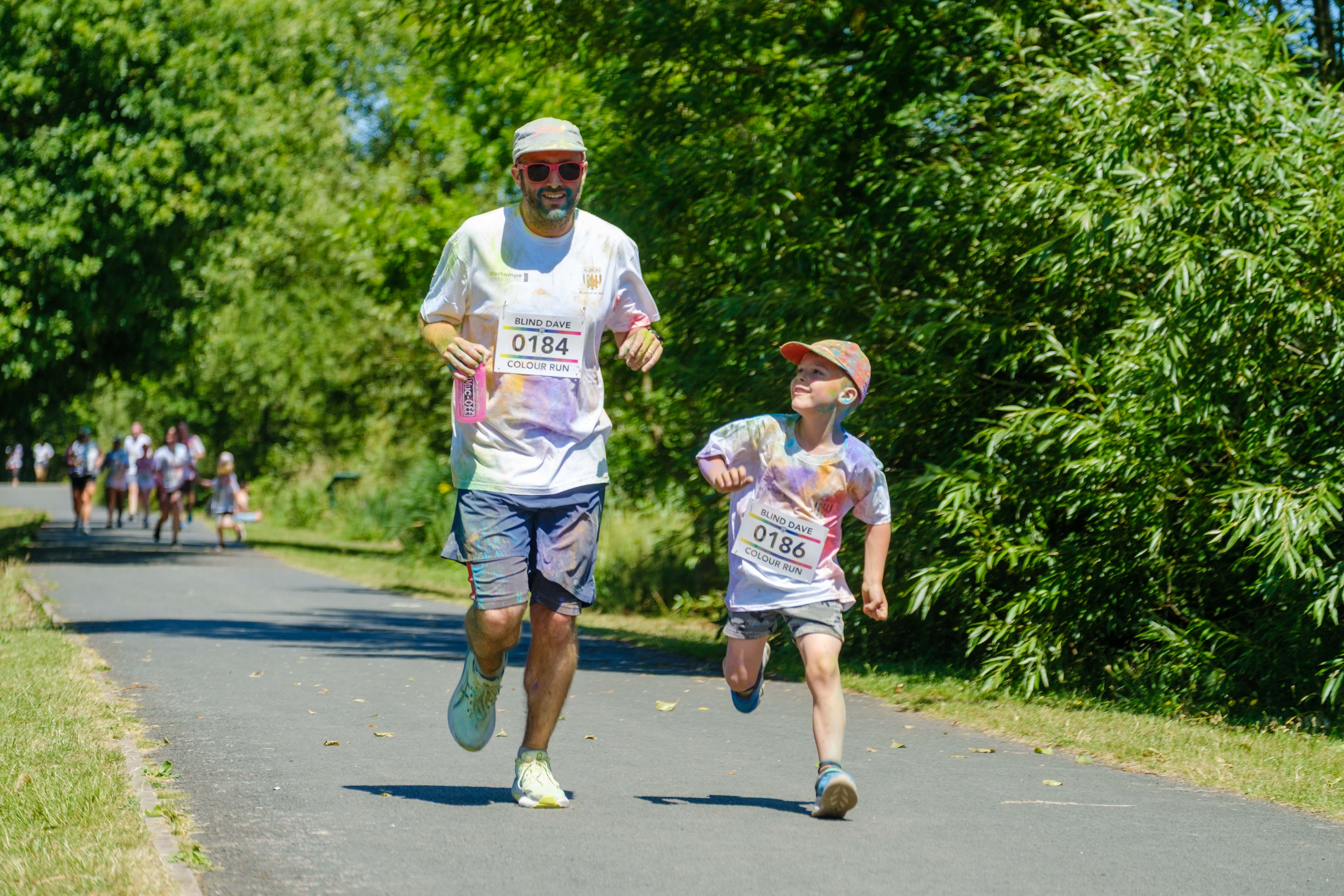 Father and son running on the path.