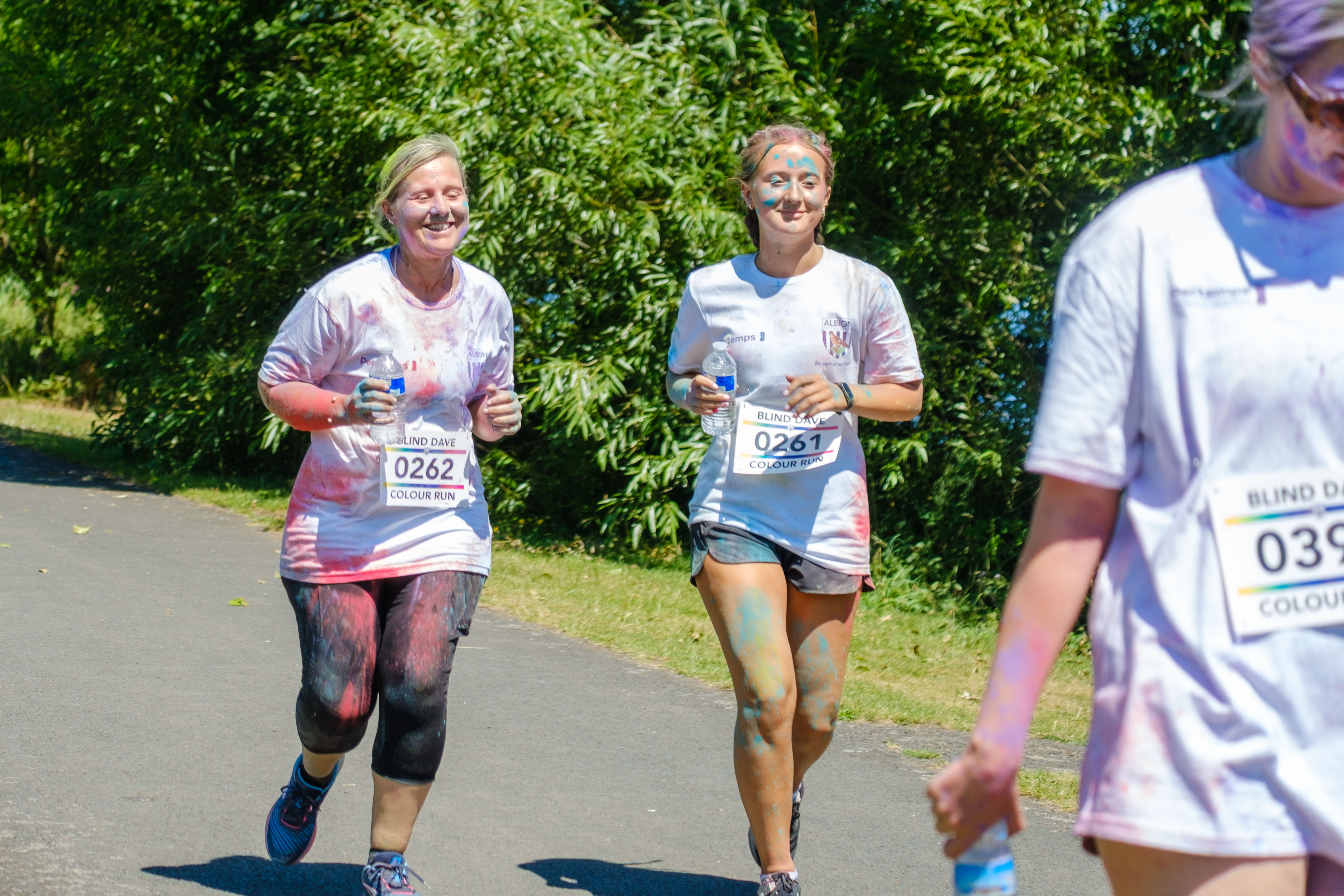 Mother and daughter running on the path.