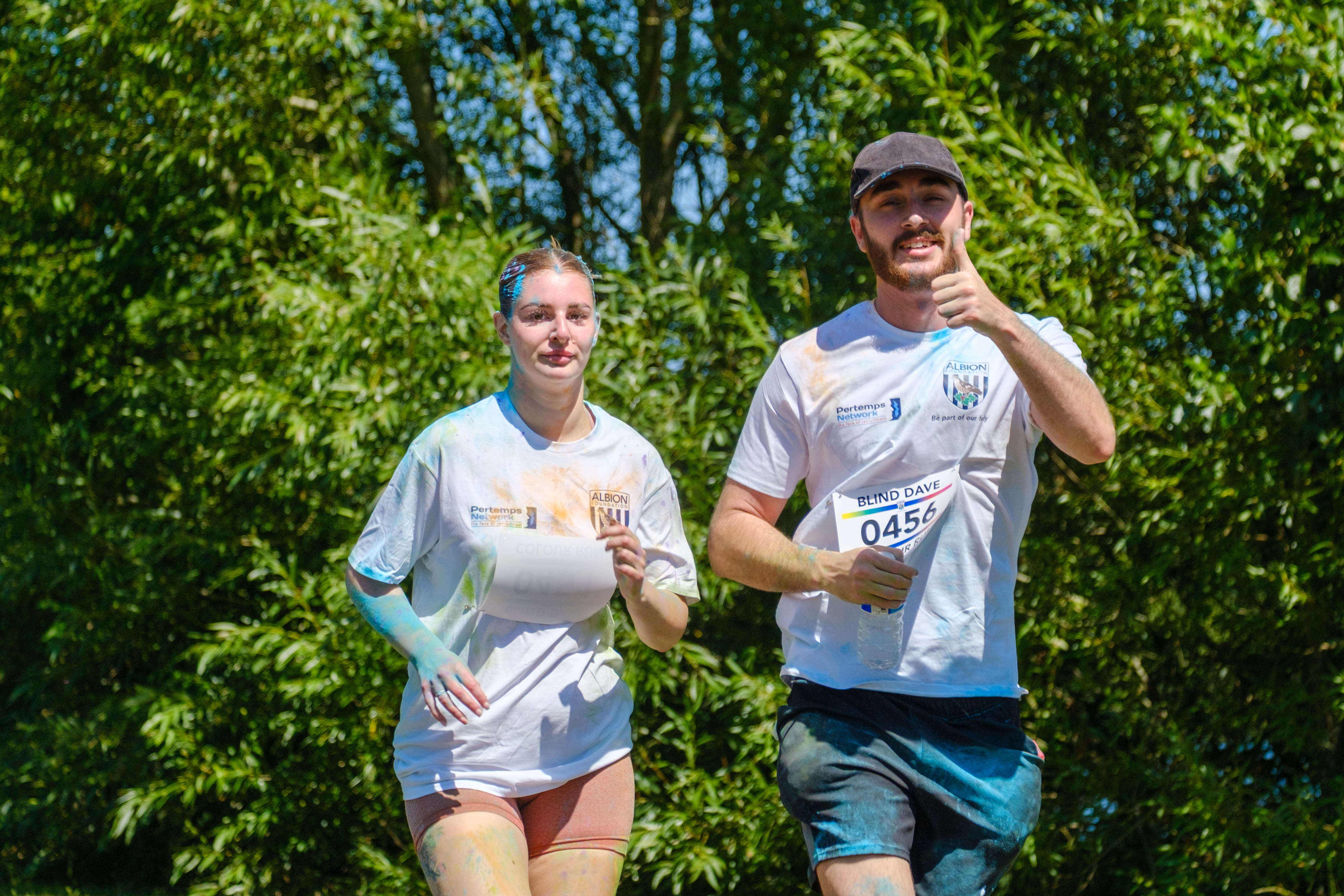 Close up of pair of runners, 0456 going the thumbs up.