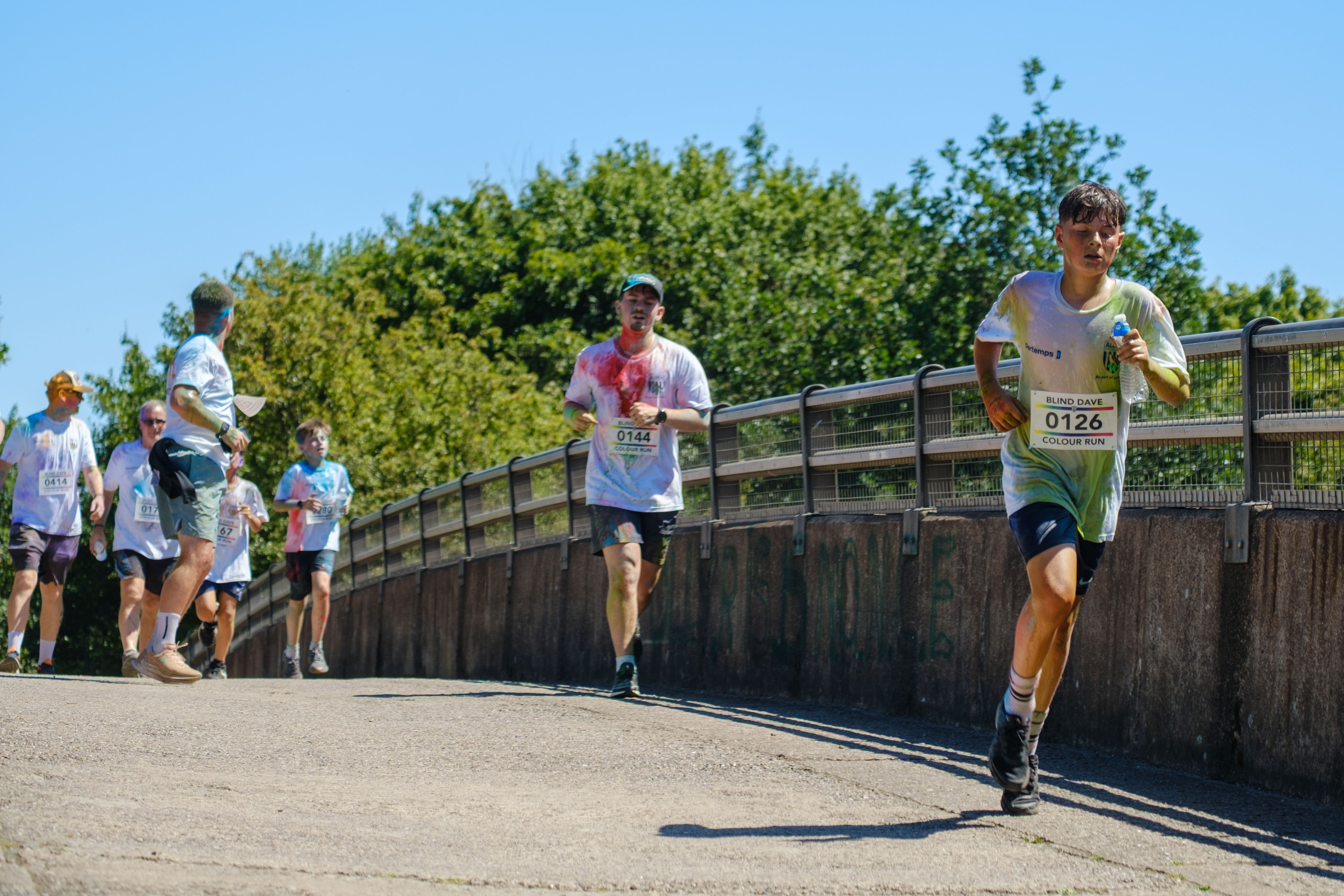 Runners crossing the motorway bridge.