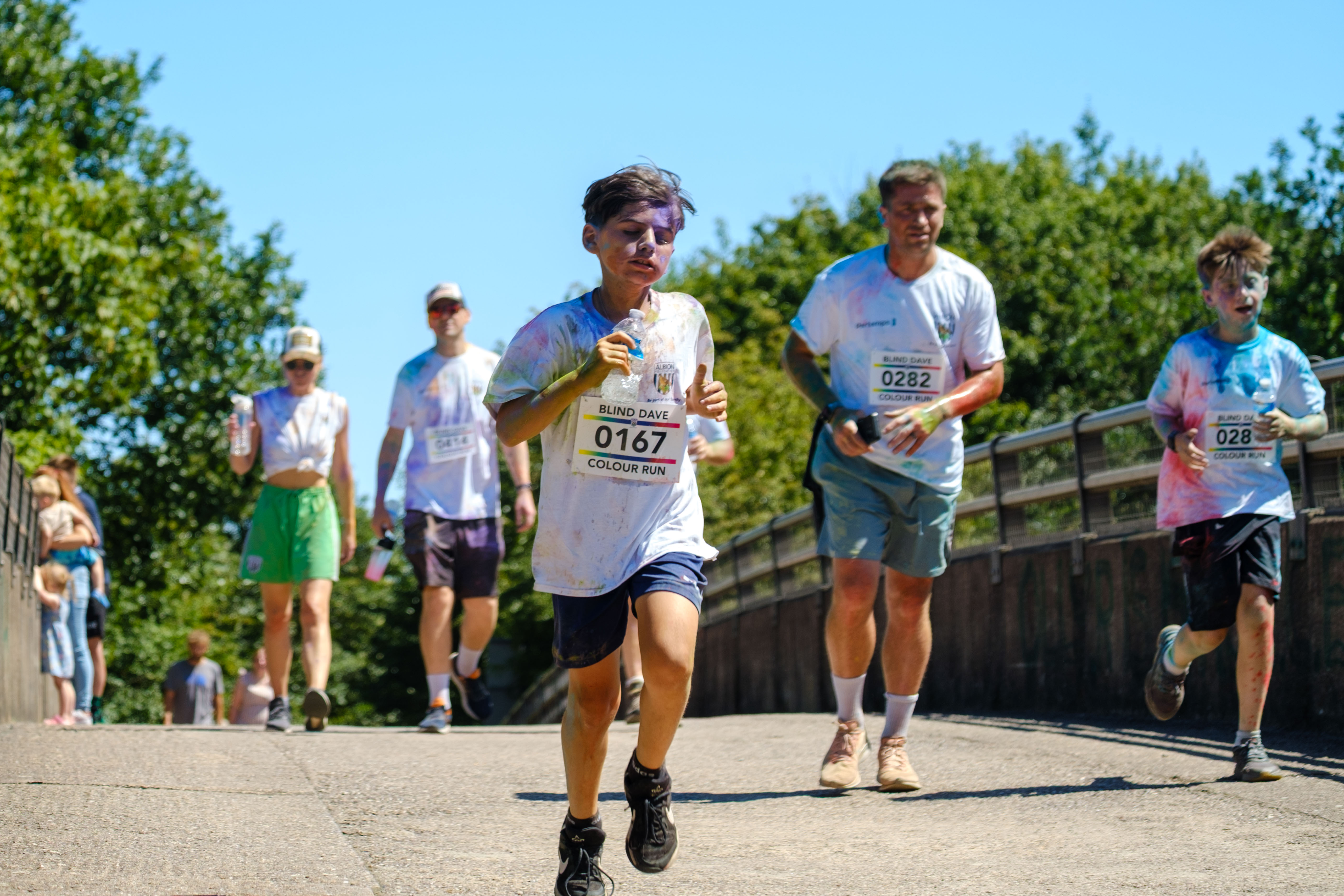 Runners crossing the motorway bridge.