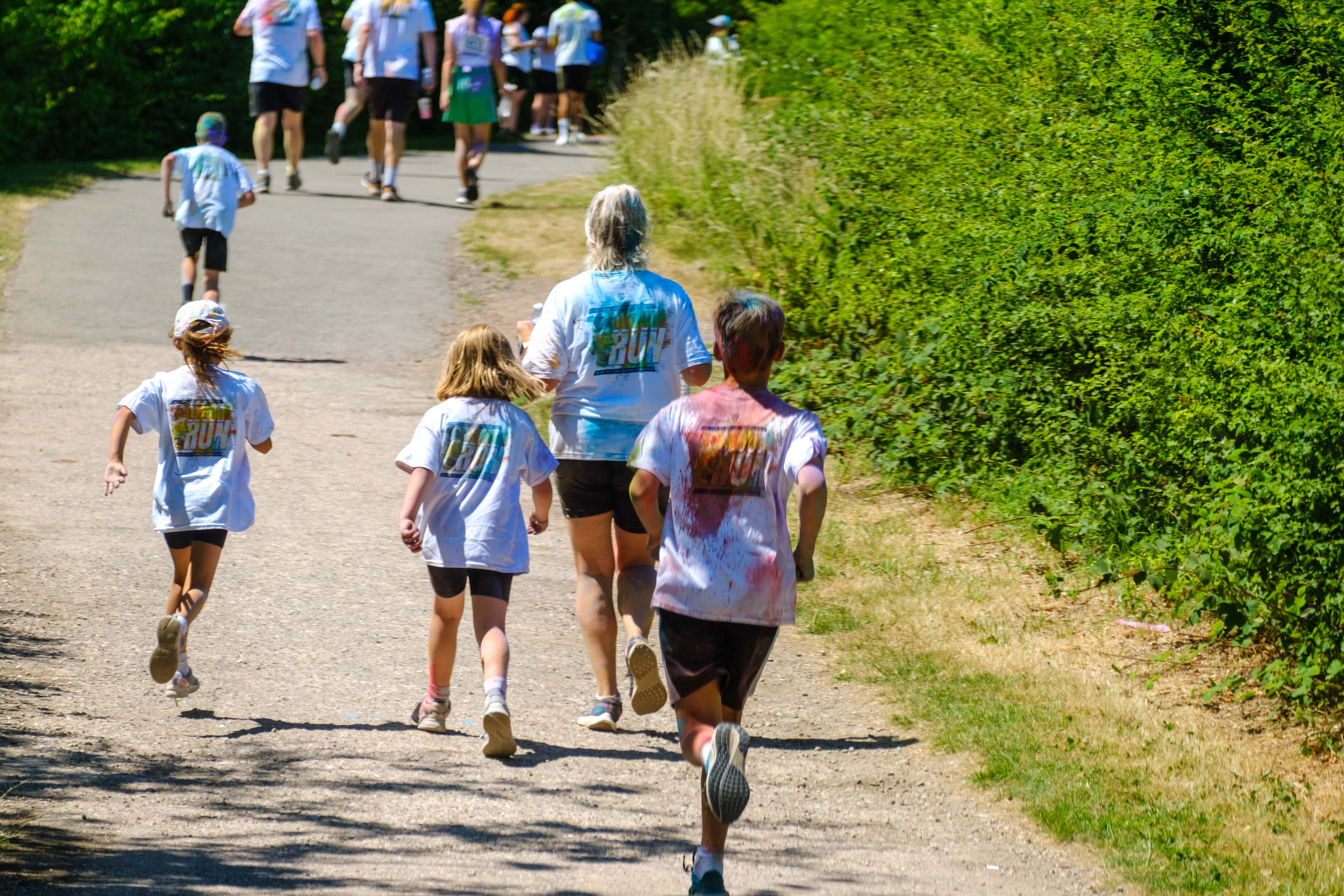 Backs of runners handing down the path.