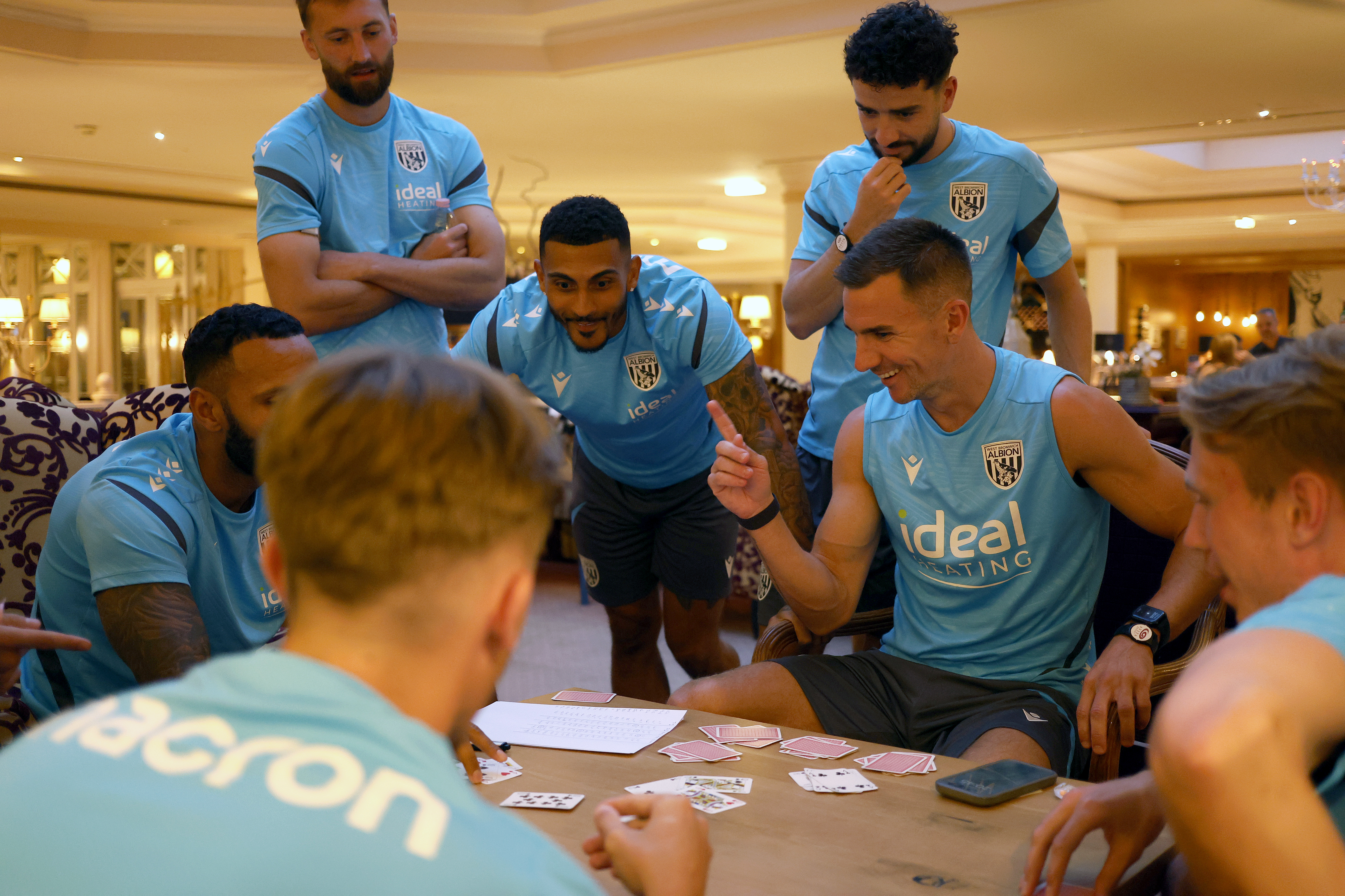 several WBA players sat round a table in Austria playing cards