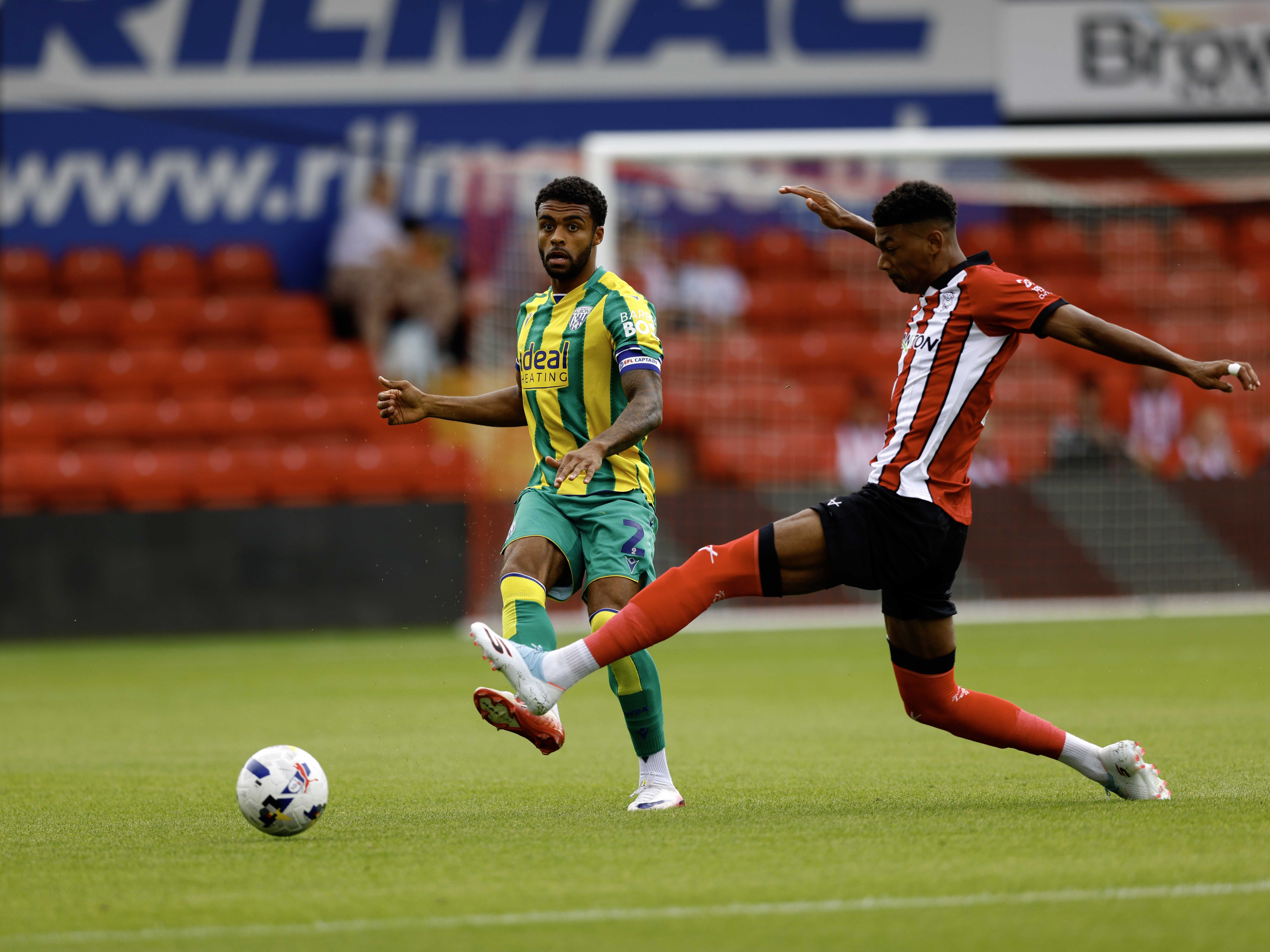 A photo of Darnell Furlong in the 2025/26 green and yellow away kit