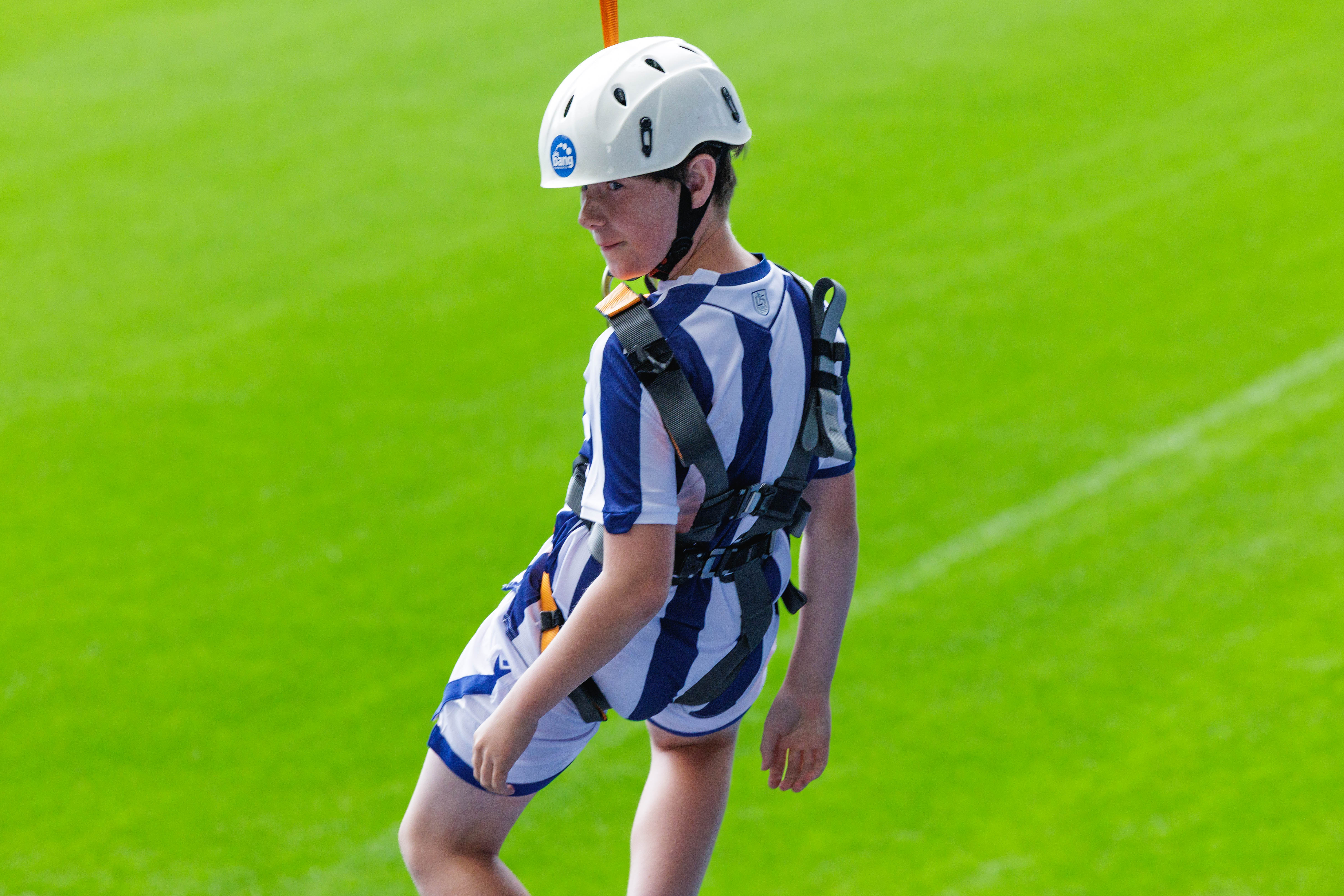 A participant zip wires across The Hawthorns.