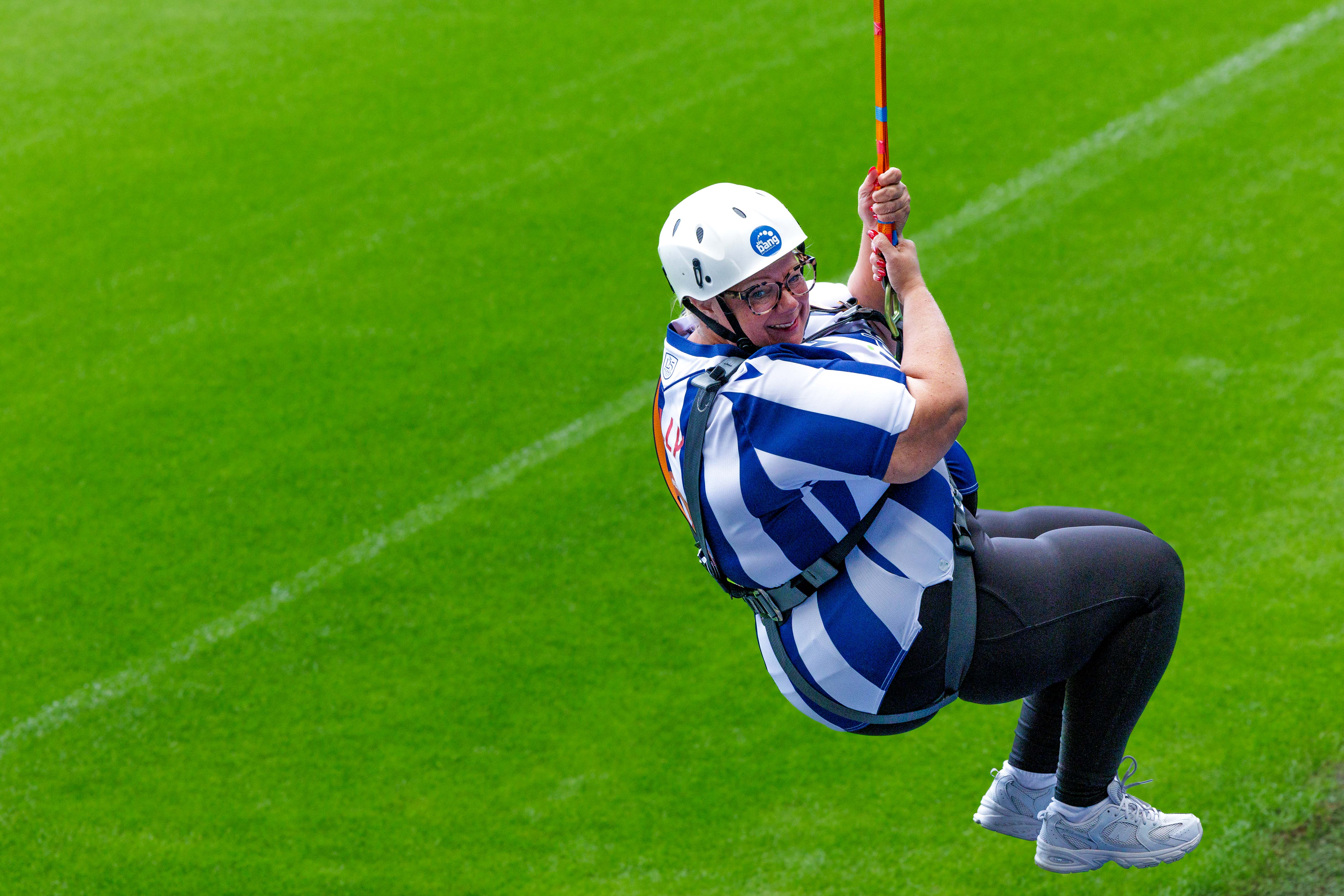 A participant zip wires across The Hawthorns.