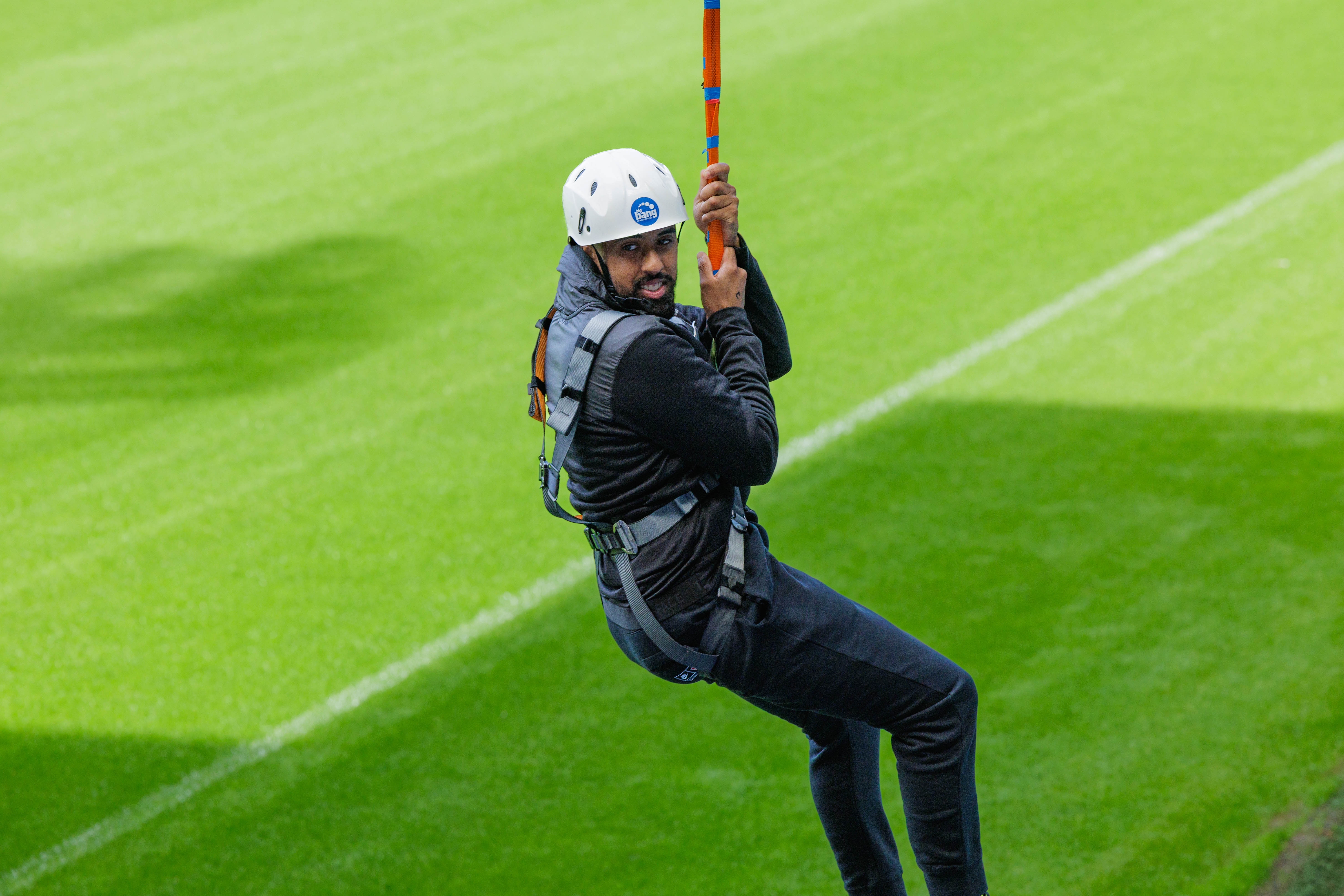 A participant zip wires across The Hawthorns.