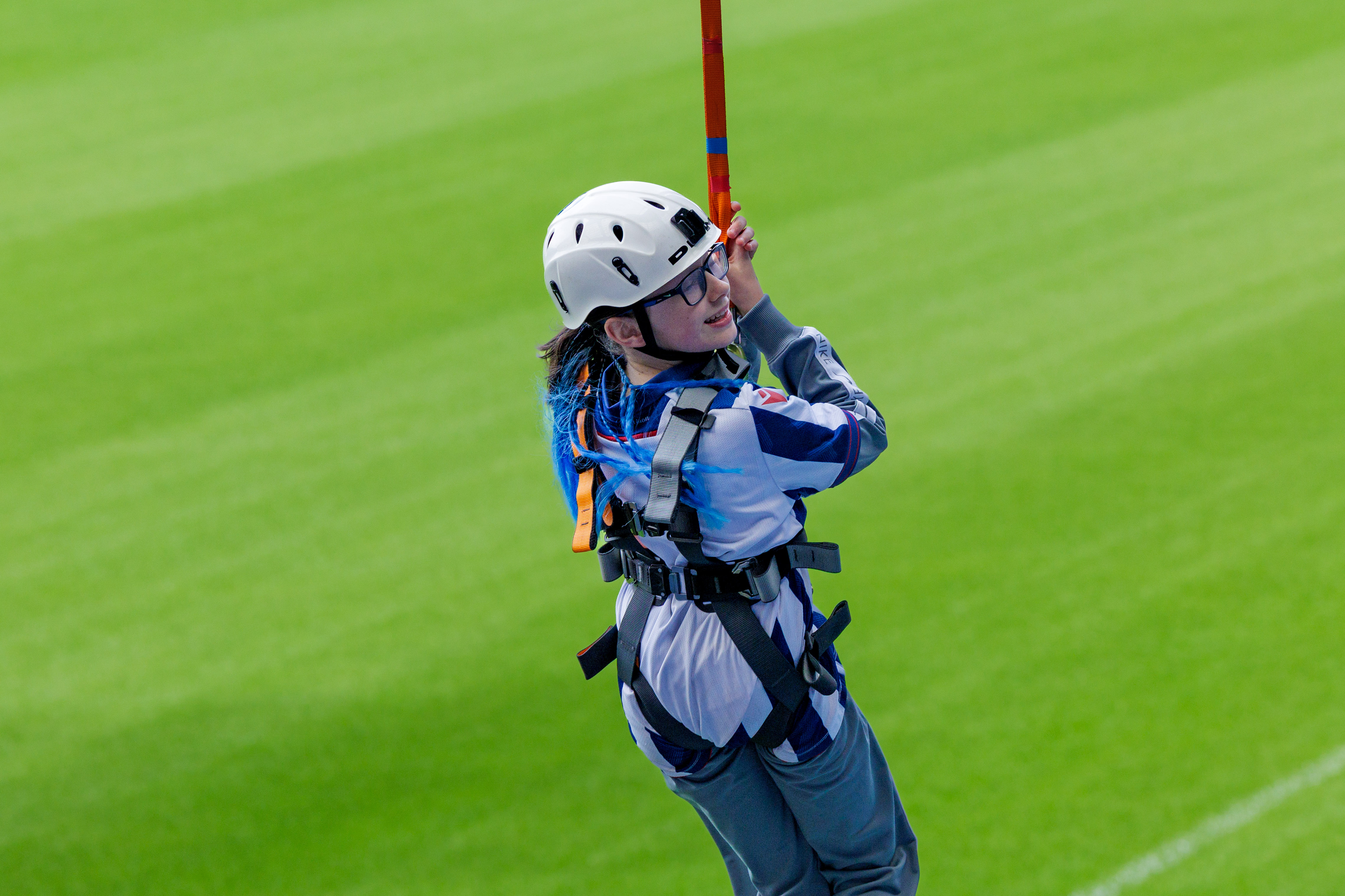 A participant zip wires across The Hawthorns.