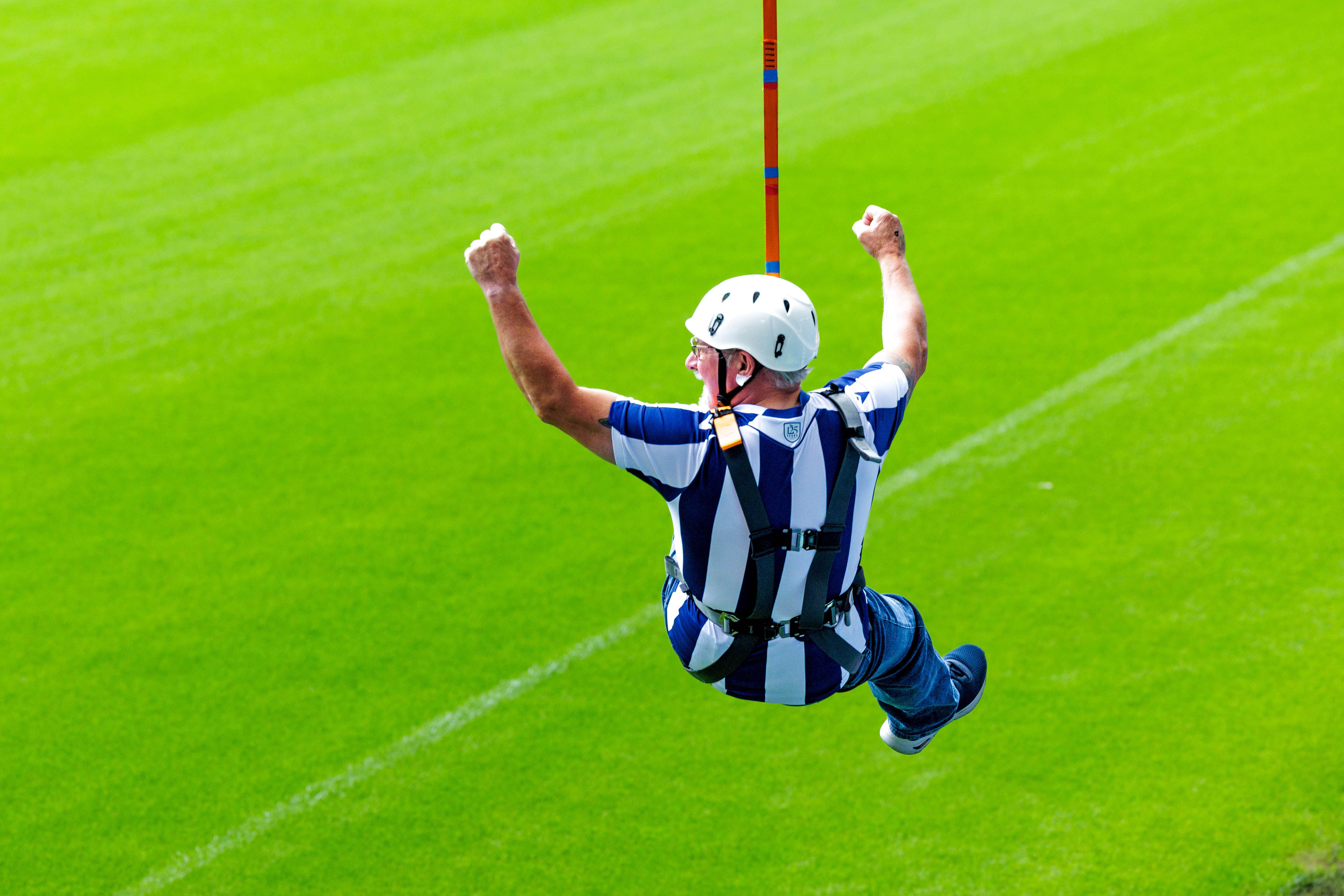 A participant zip wires across The Hawthorns.