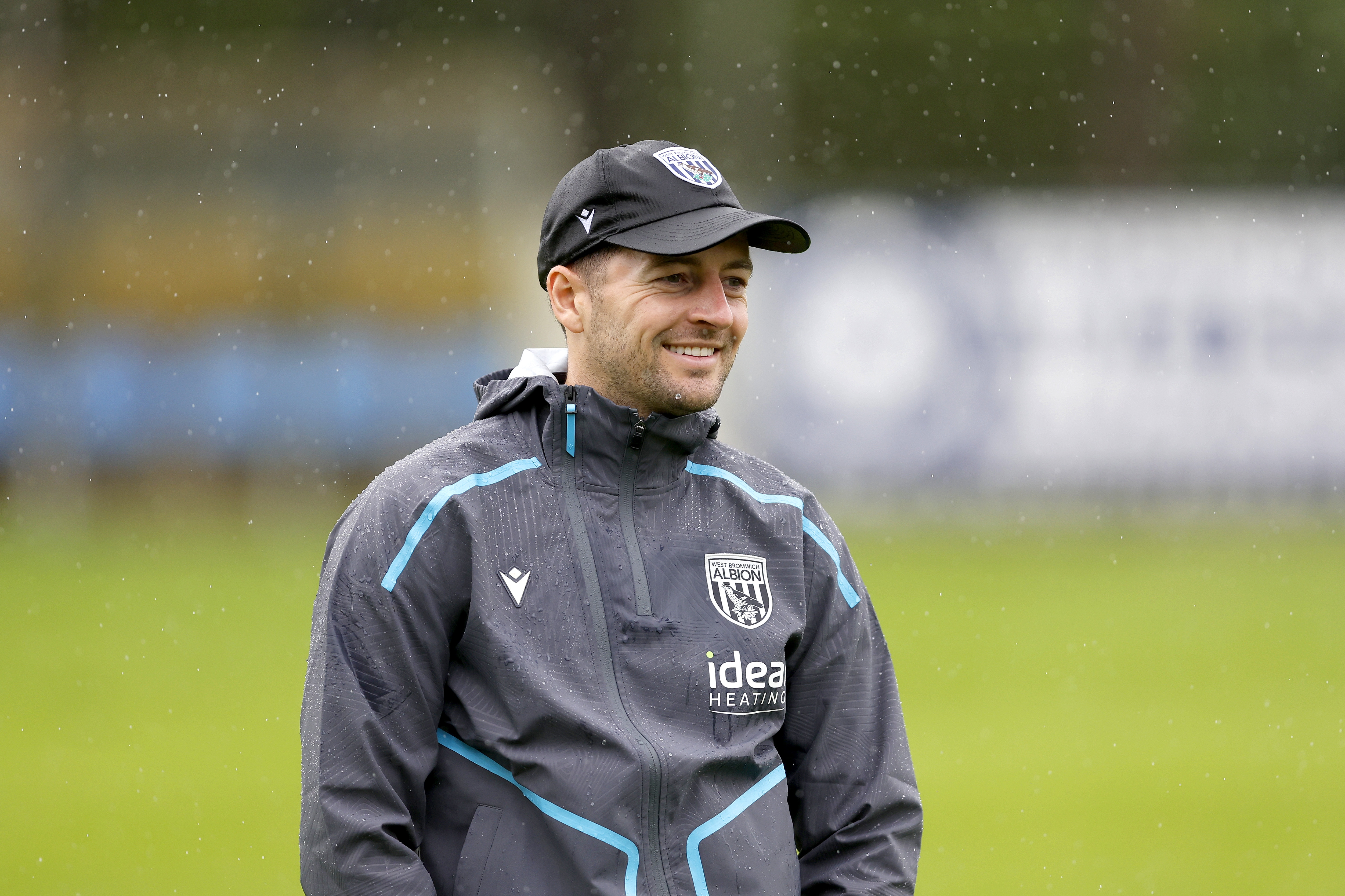 Ryan Mason smiling while wearing a cap during a session out in Austria
