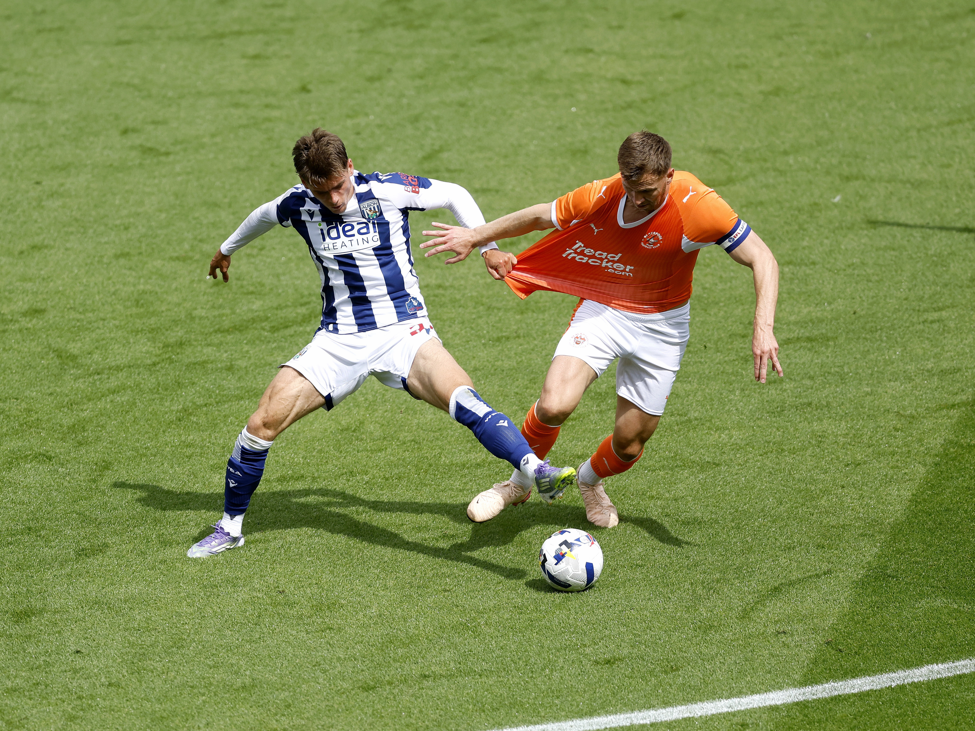 An image of Tom Fellows battling for the ball against Blackpool