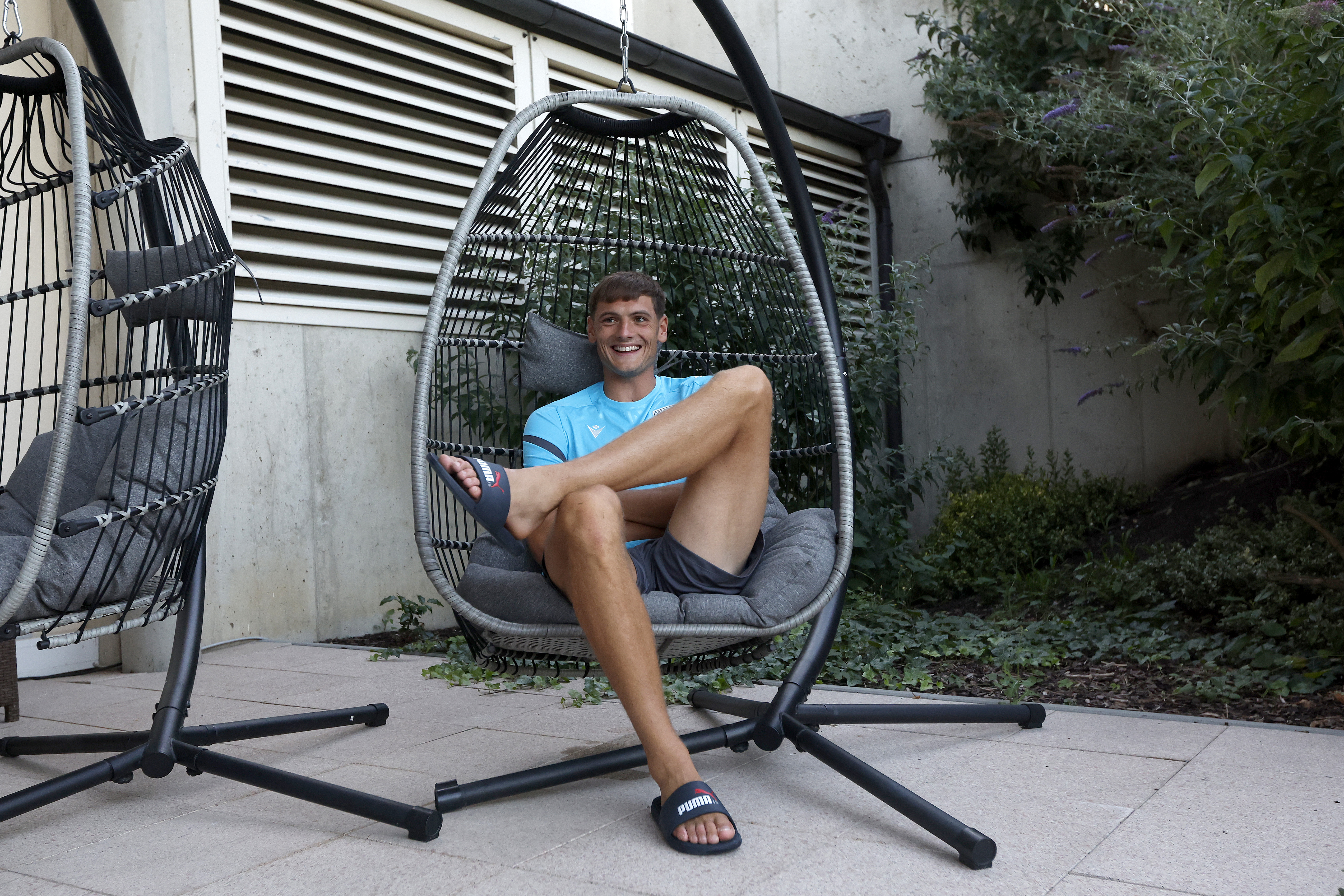 Caleb Taylor sat on a swinging chair in Austria