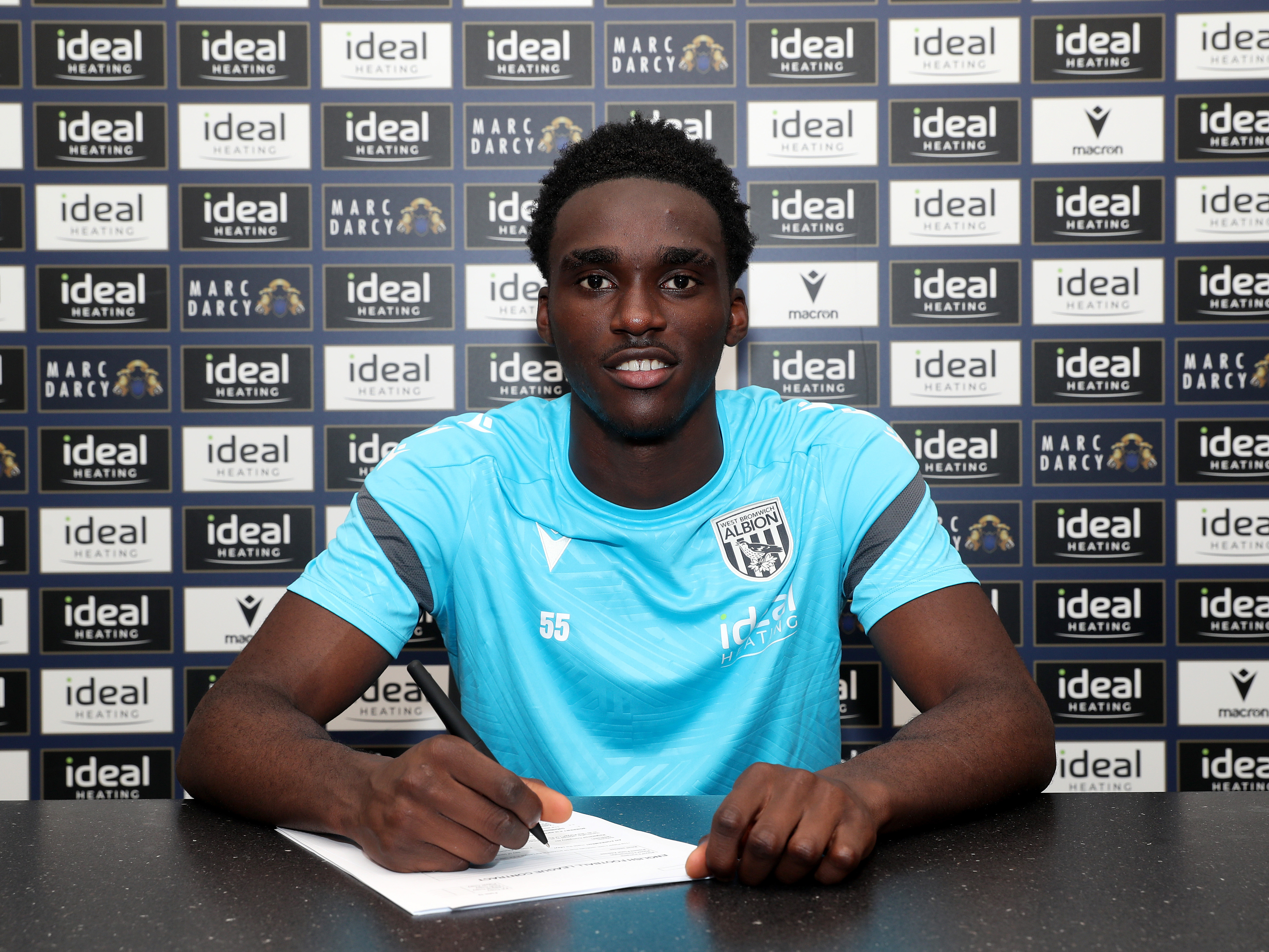 A photo of Dan Chimeziri signing his first professional Albion contract
